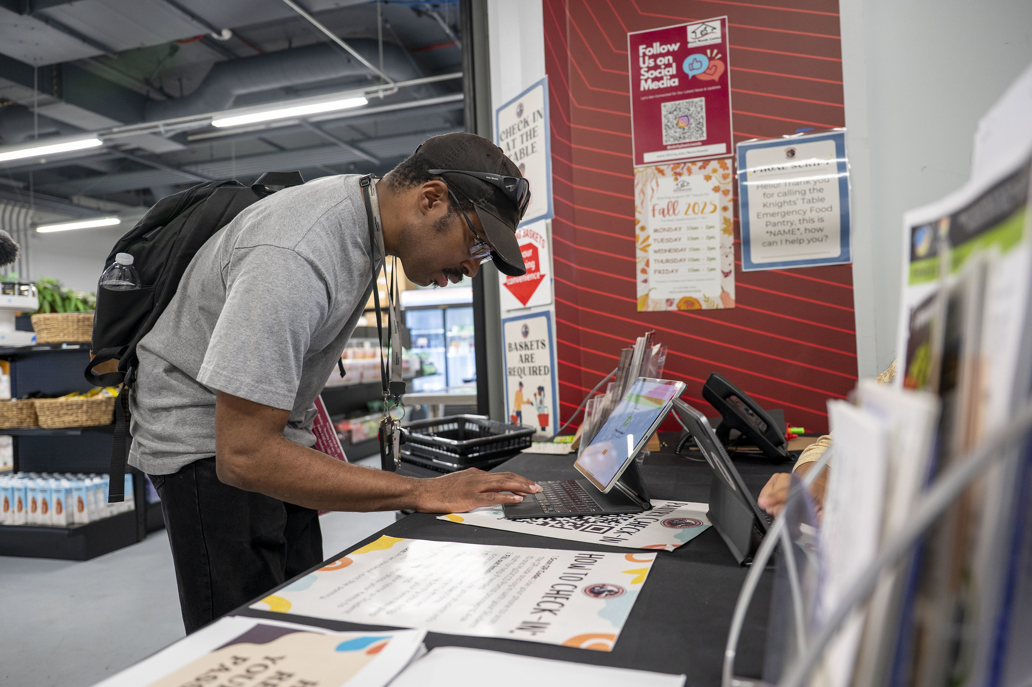 
A student checks in on a tablet at the food pantry.
