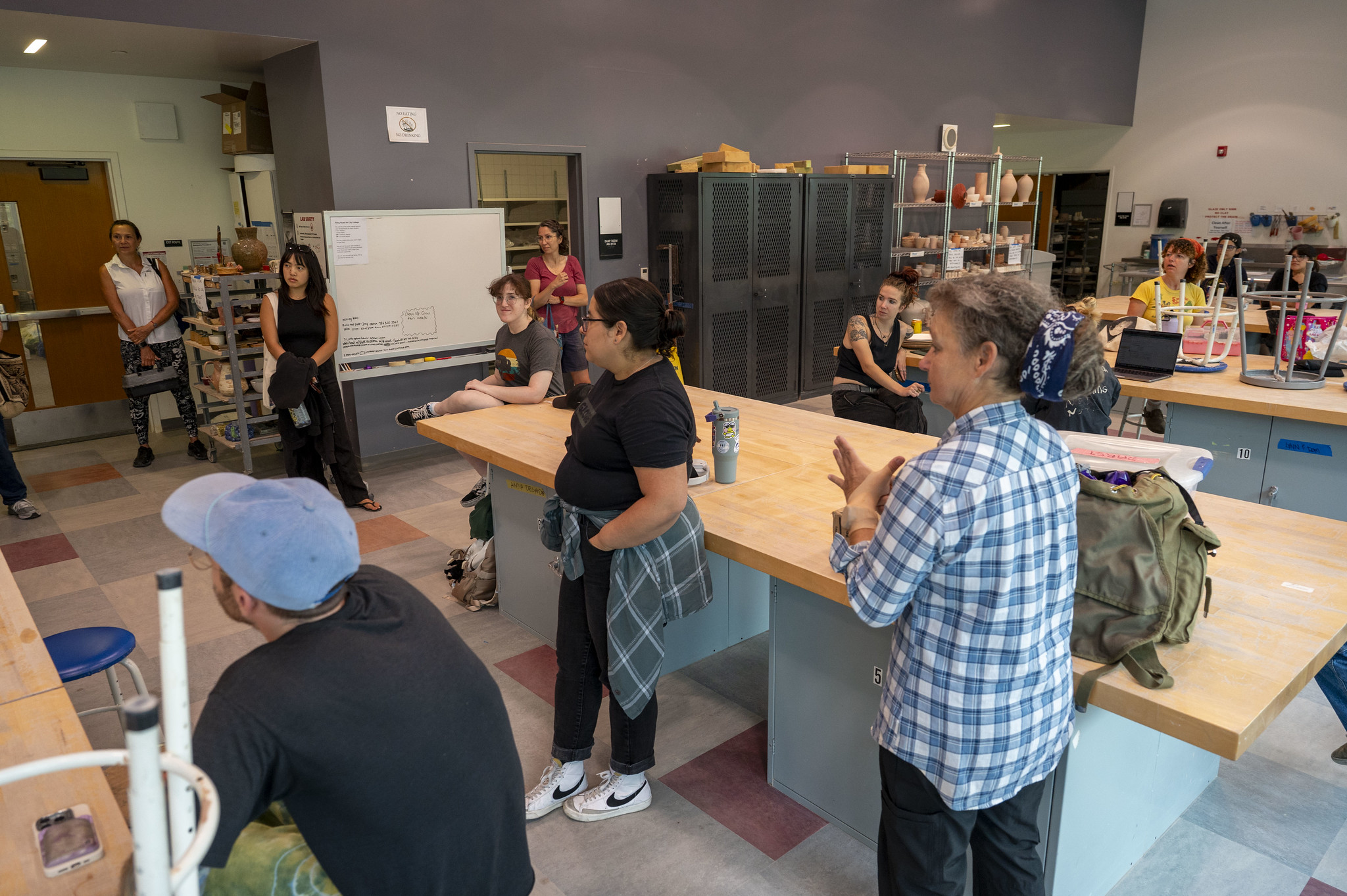 
Students in a ceramics class listen to the instructor.
