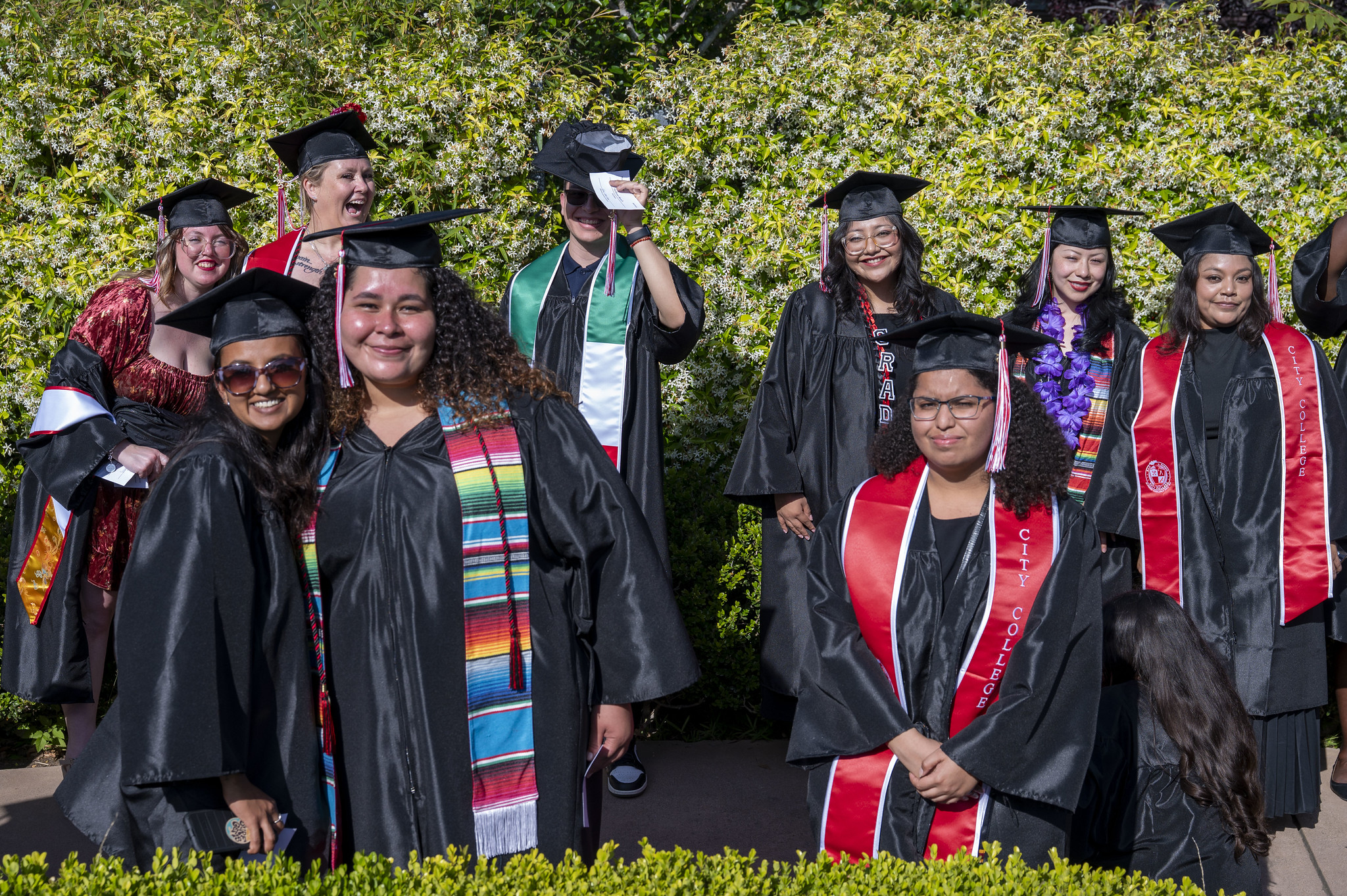 
Nine graduates outside waiting to take their seats before commencement
