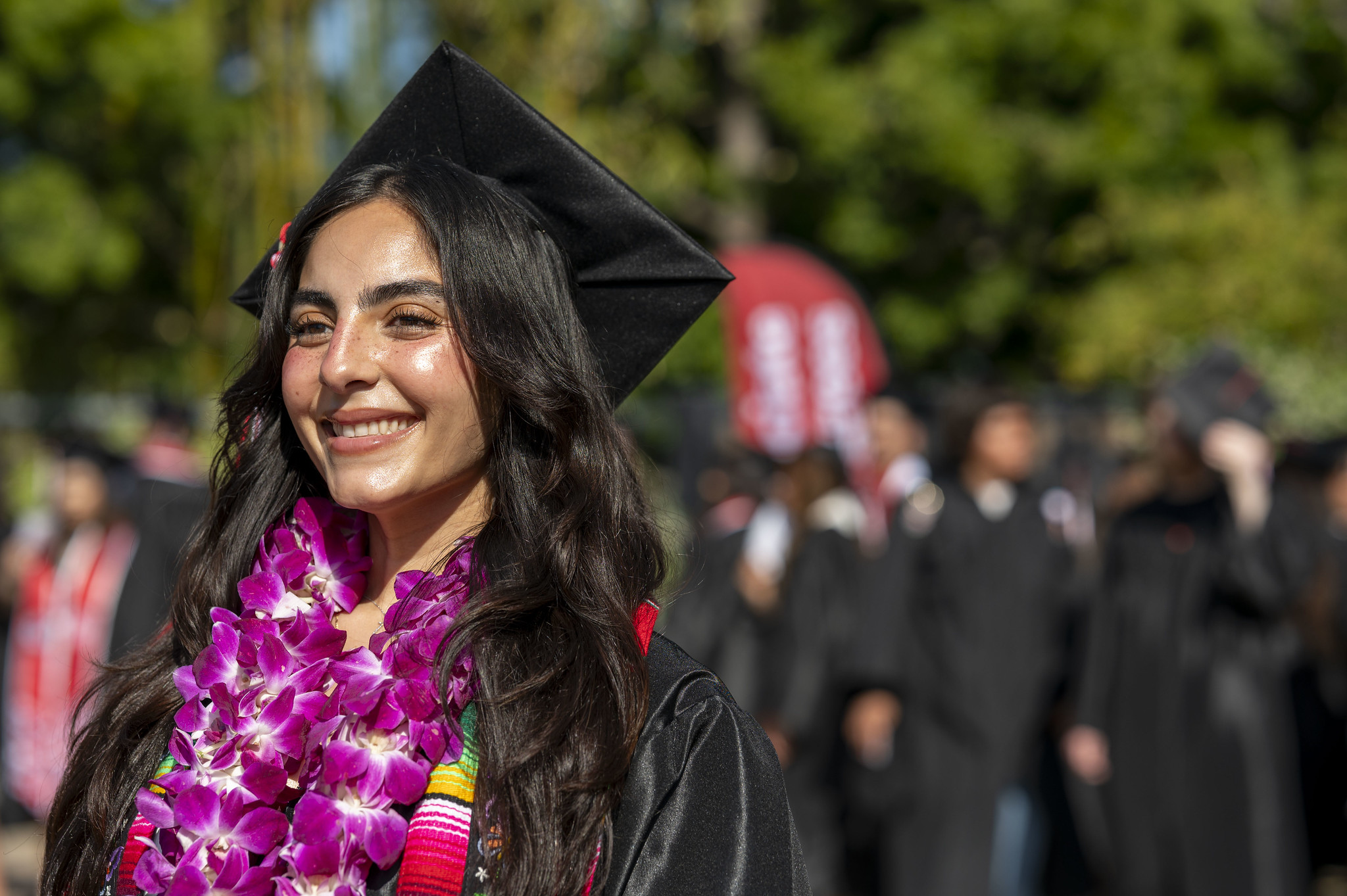 
A graduate with a purple lei.
