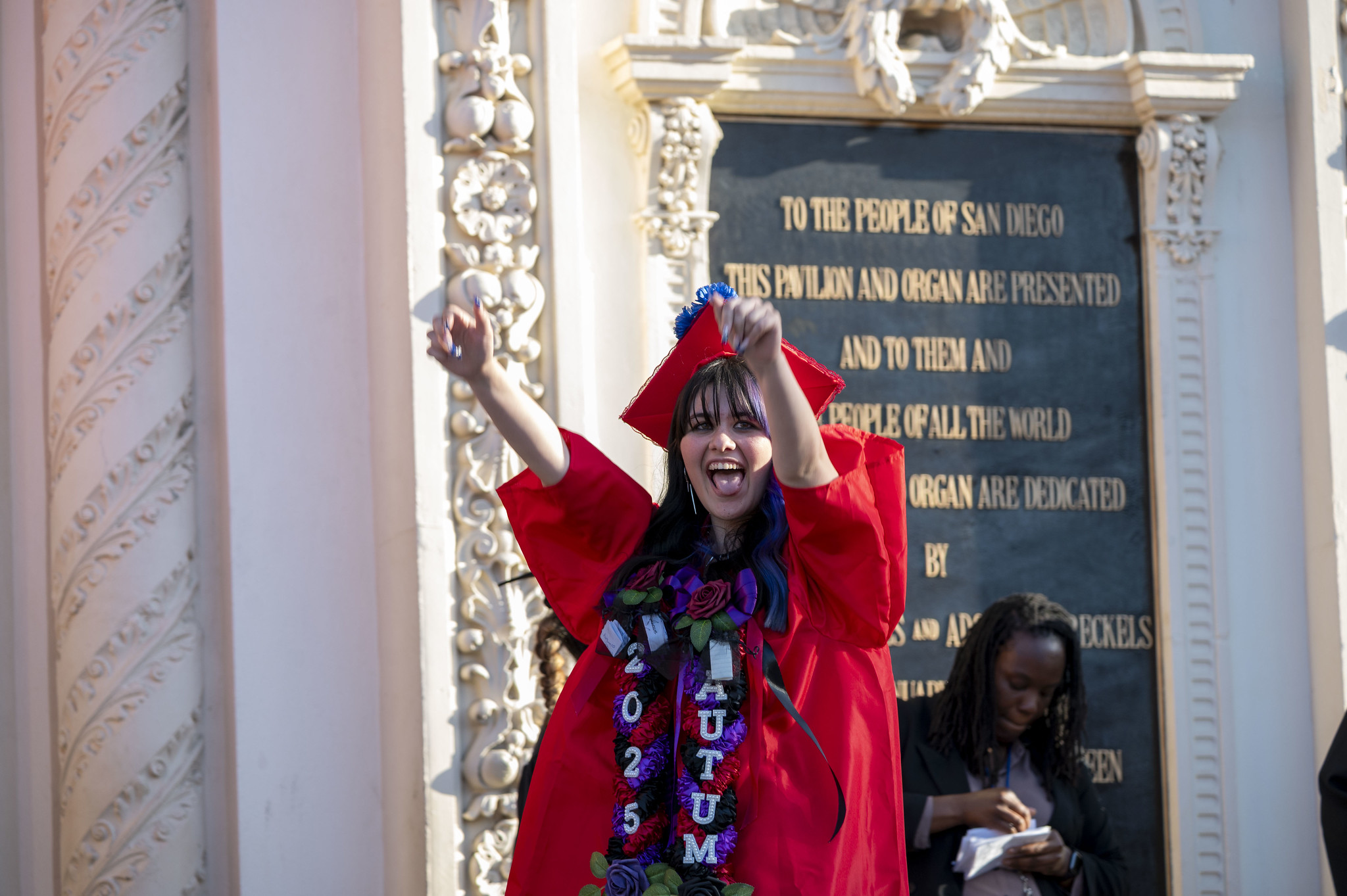 
A graduate cheers as she crosses the stage.
