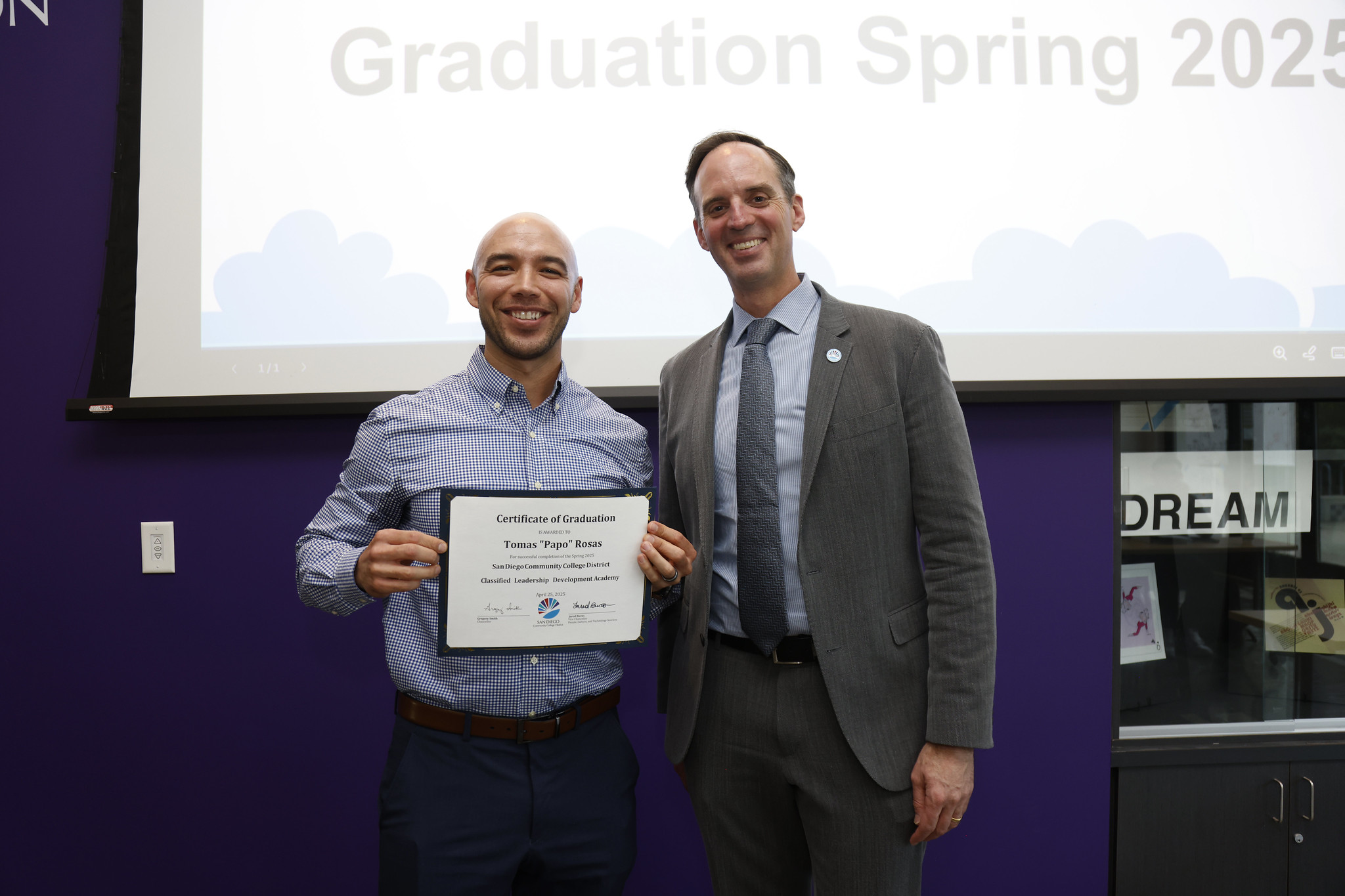 
Tomas "Papo" Rosas holds his certificate with the chancellor

