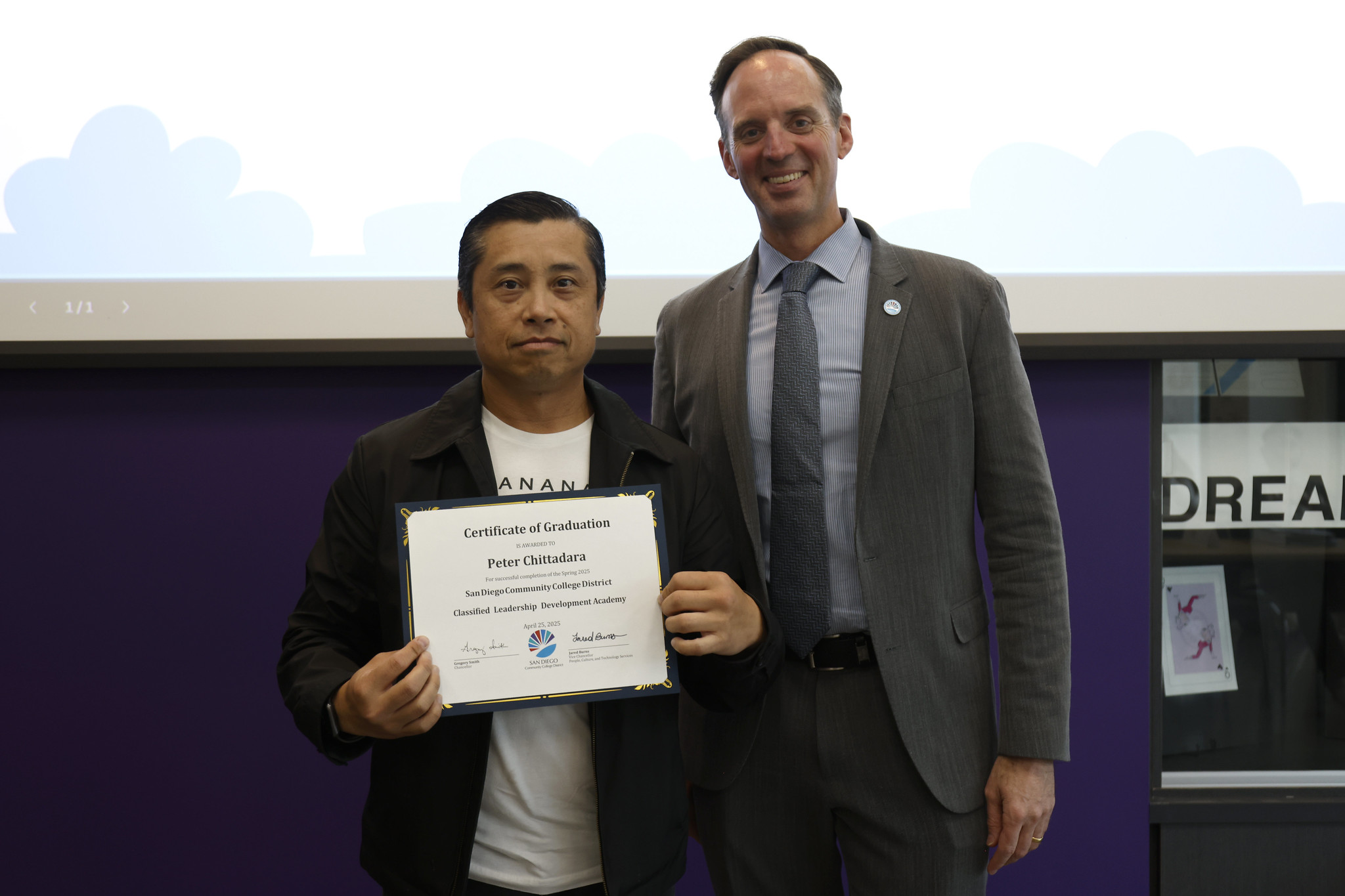 
Peter Chittadara holds his certificate with the chancellor.
