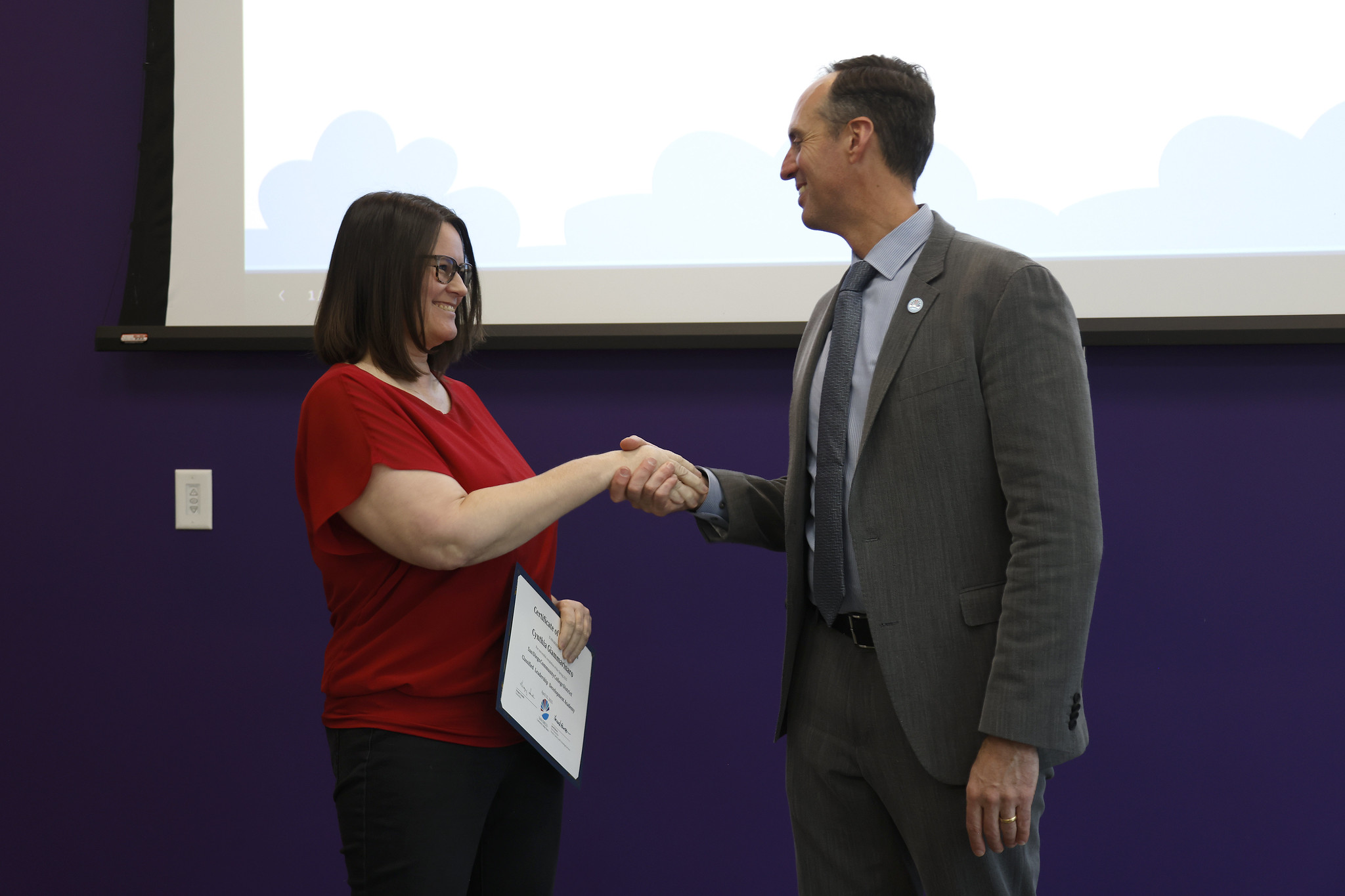 
Cynthia Glammarians shakes the chancellors hand as she receives her certificate.
