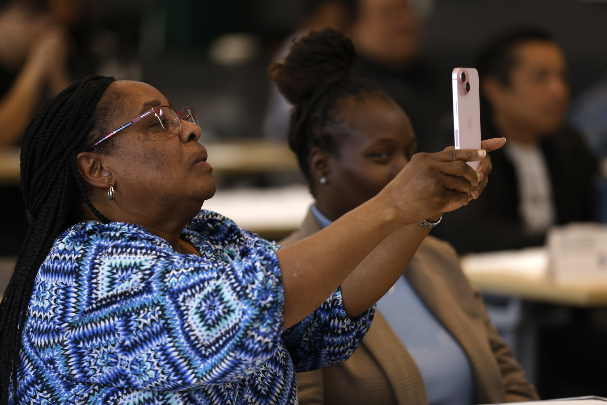 
Renee Darden takes a picture of the screen at the event.
