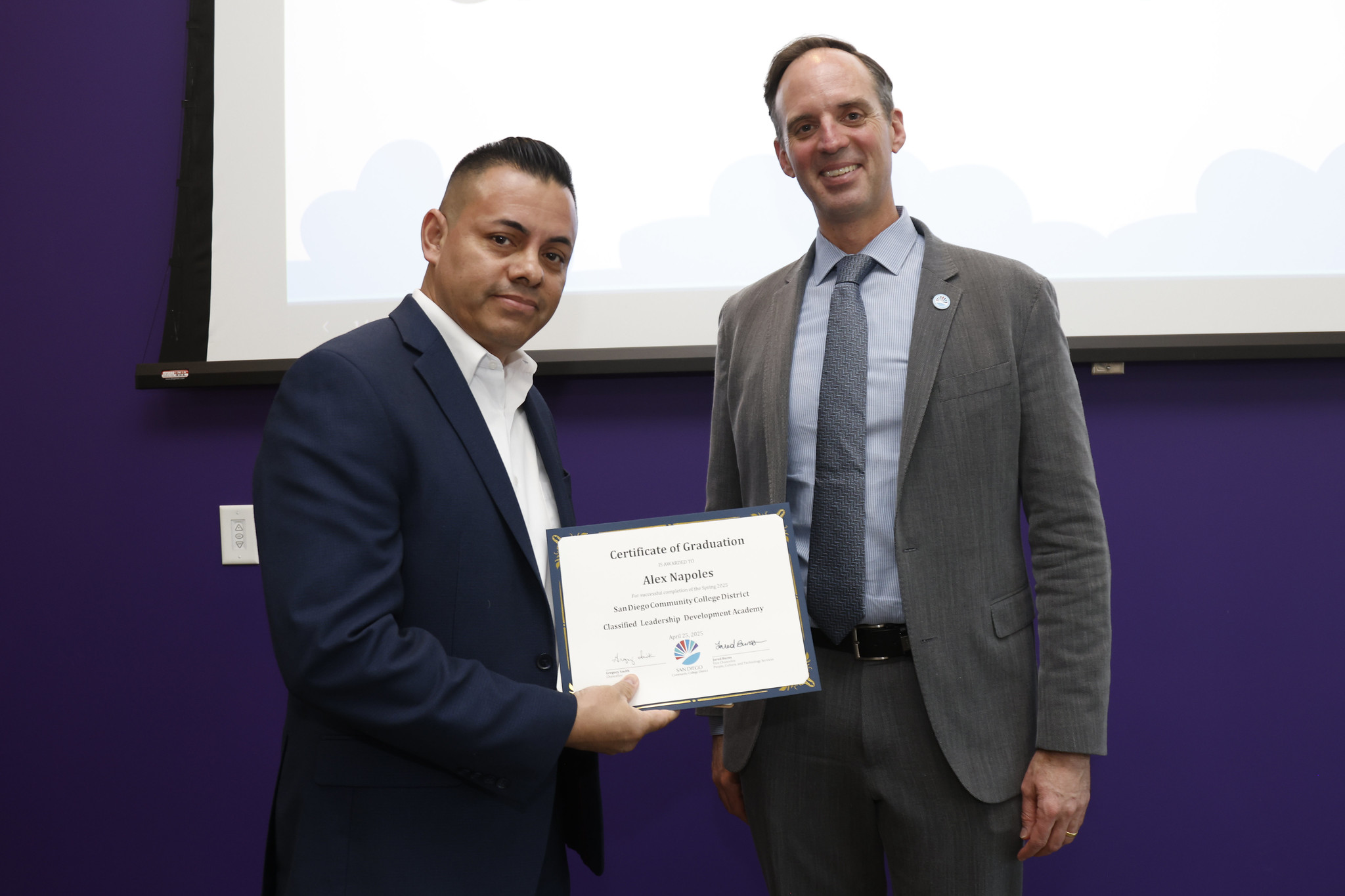 
Alex Napoles holds his certificate with the chancellor.
