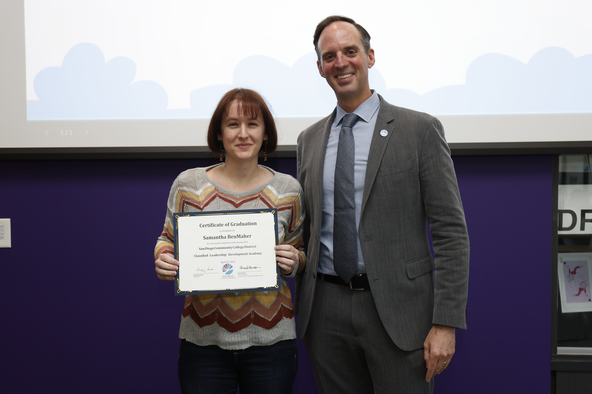 
Samantha BeuMaher holds her certificate with the chancellor.
