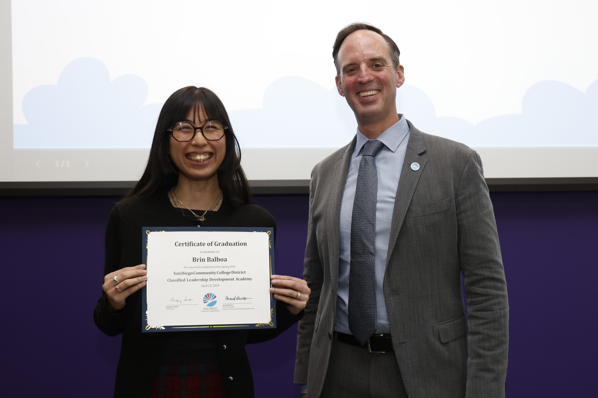 
Brin Balboa holds her certificate with the chancellor.
