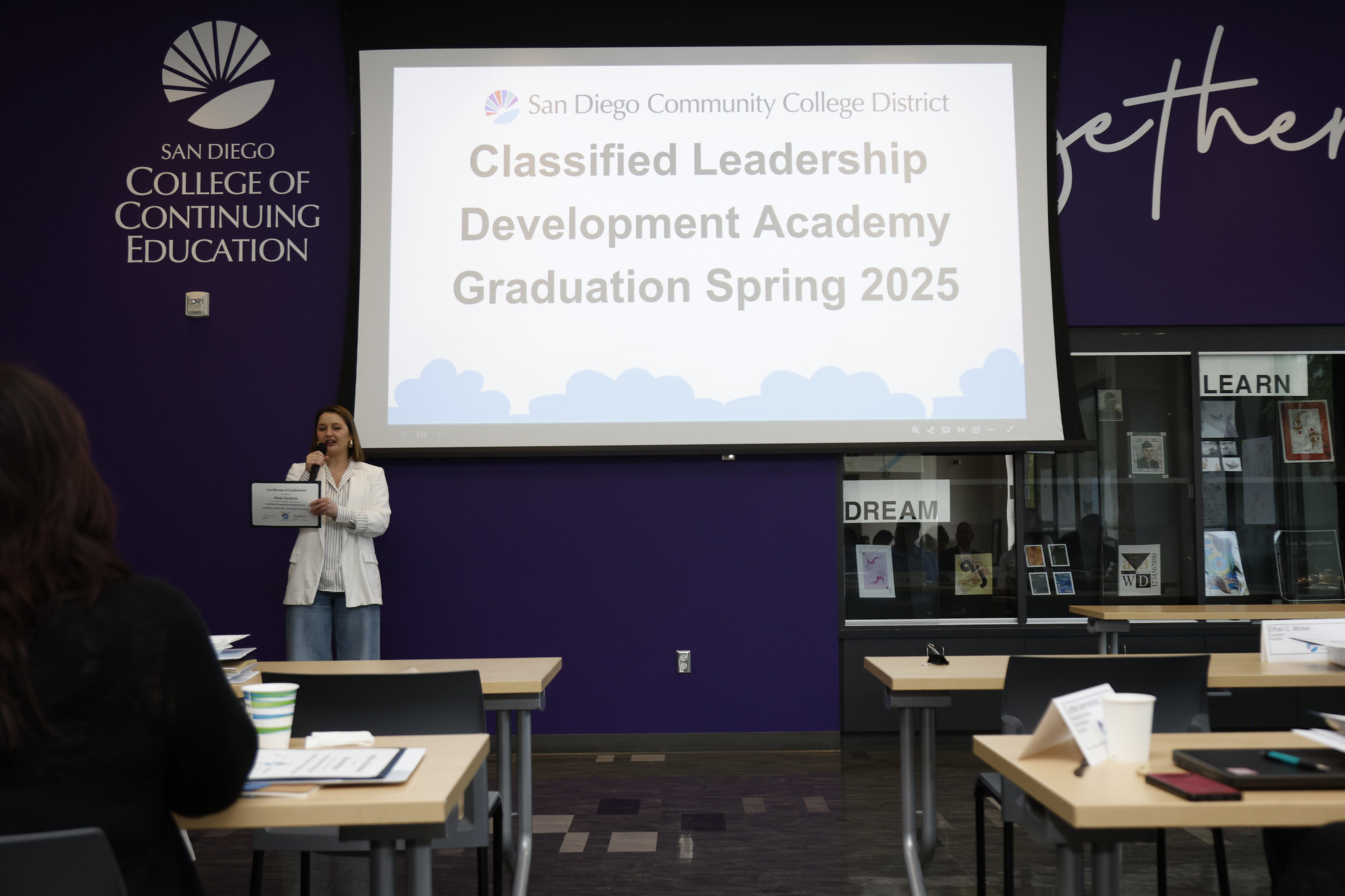 
A woman speaks to the audience after receiving her certificate.
