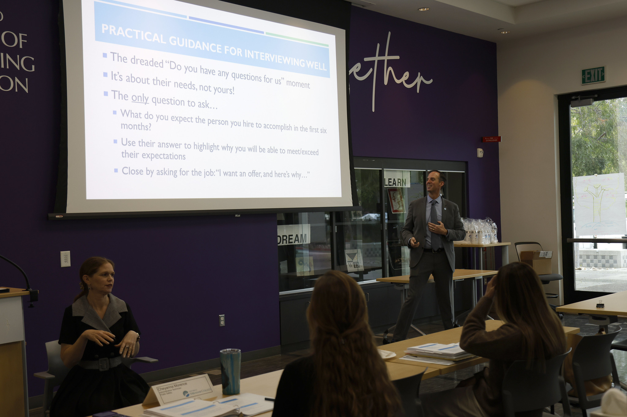 
The chancellor looks to the screen while speaking to the audience.

