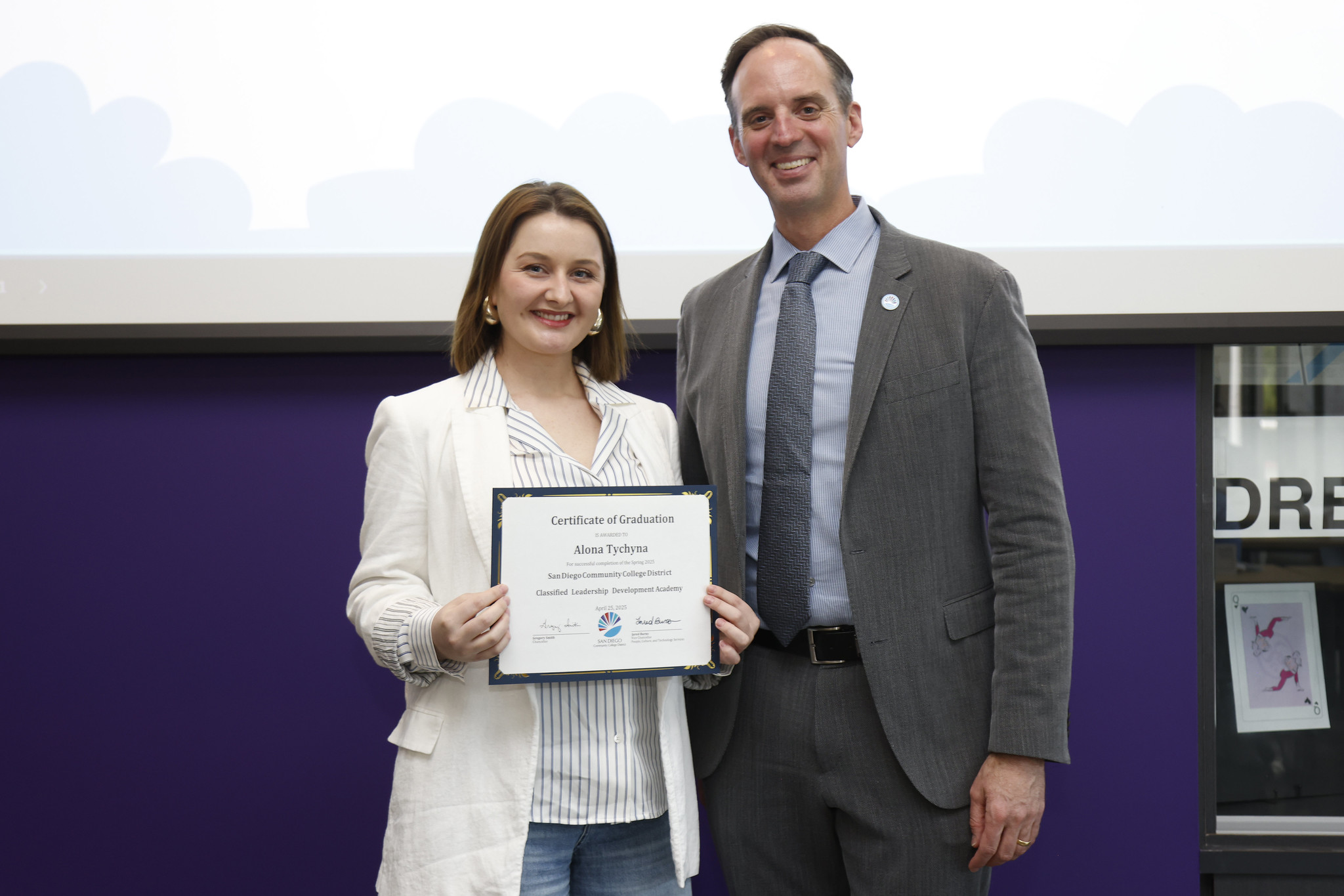 
Alona Tychyna holds her certificate with the chancellor.

