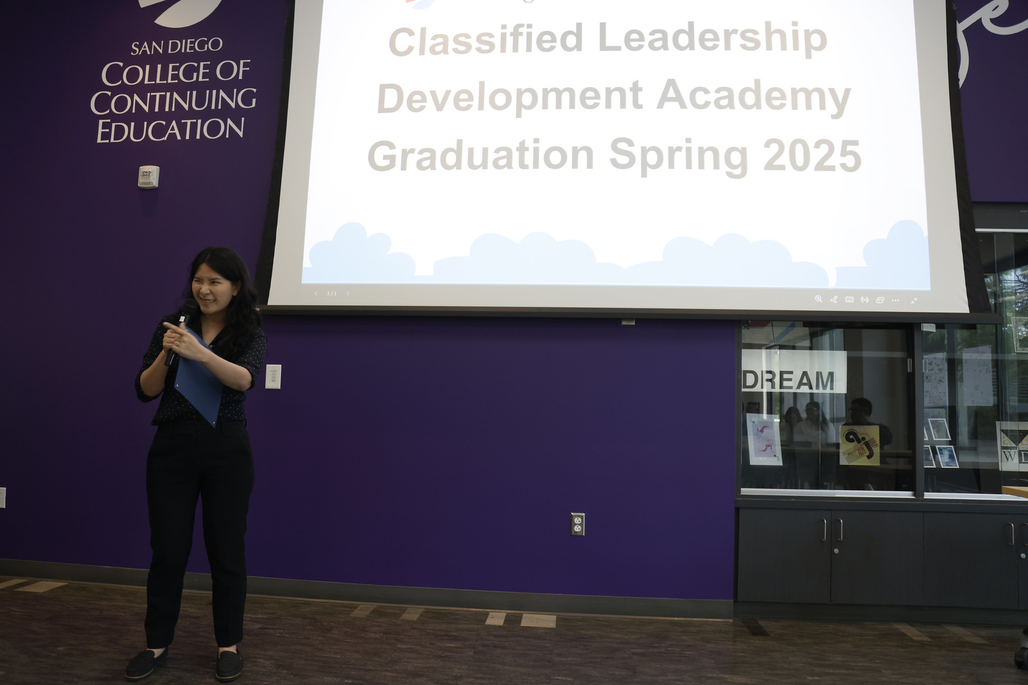 
A woman speaks to the audience.
