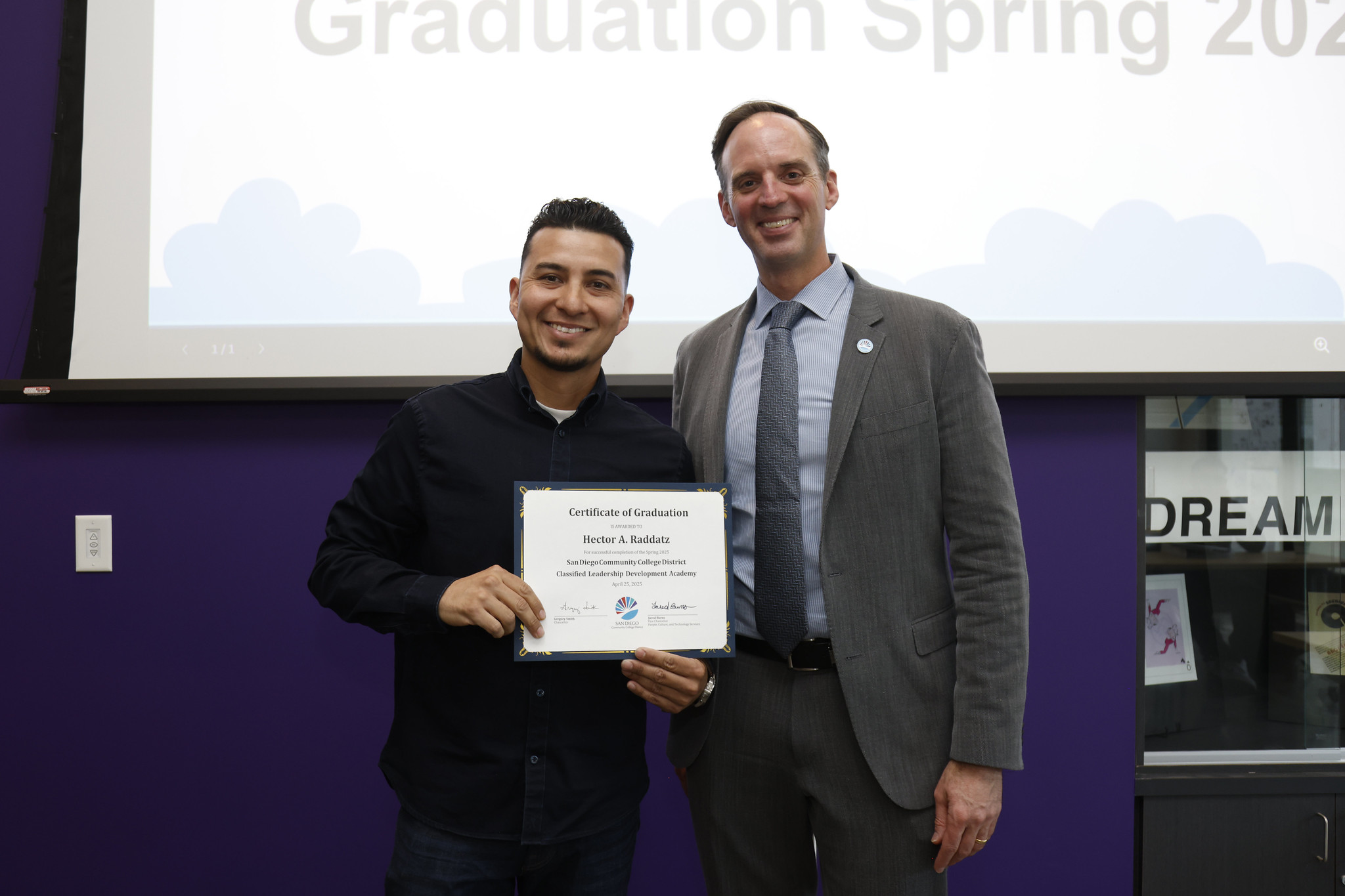 
Hector Raddatz holds his certificate with the chancellor.
