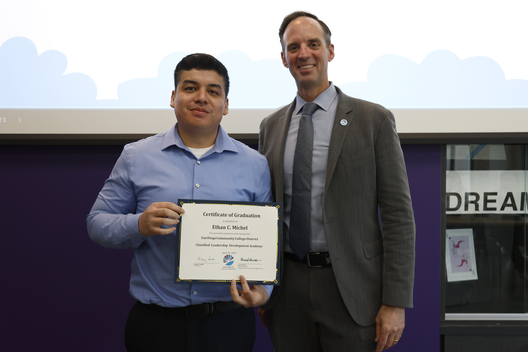 
Ethan Michel holds his certificate with the chancellor.
