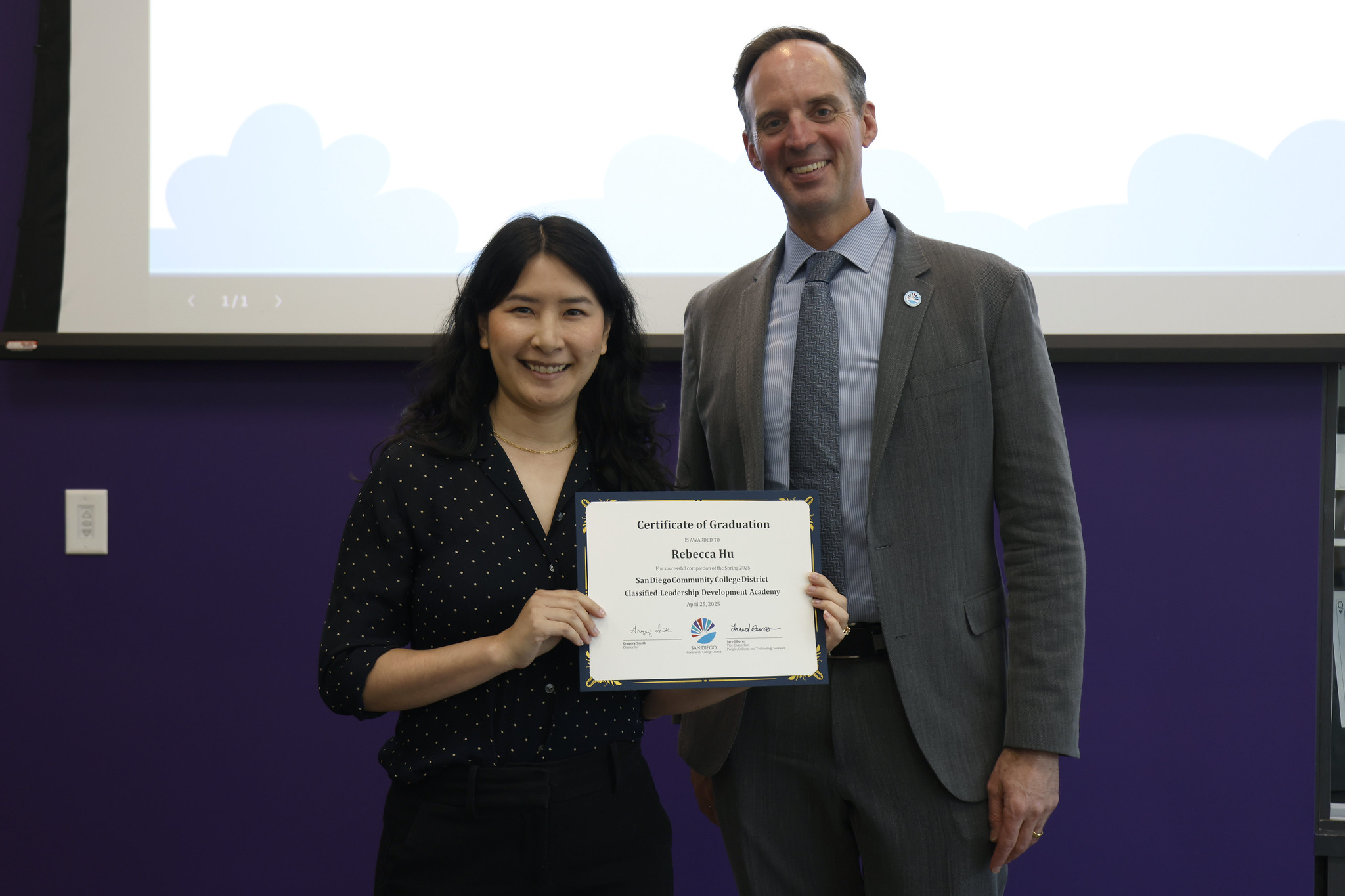 
Rebecca Hu holds her certificate with the chancellor.
