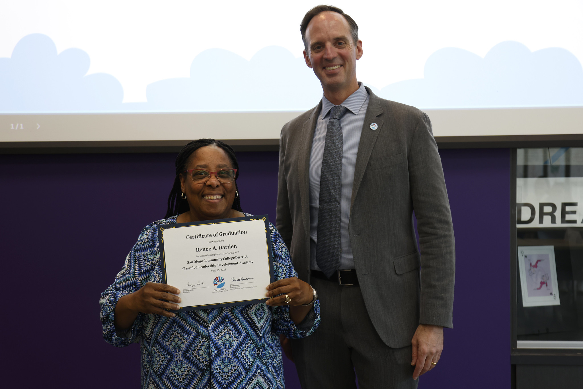 
Renee Darden holds up her certificate with the chancellor.
