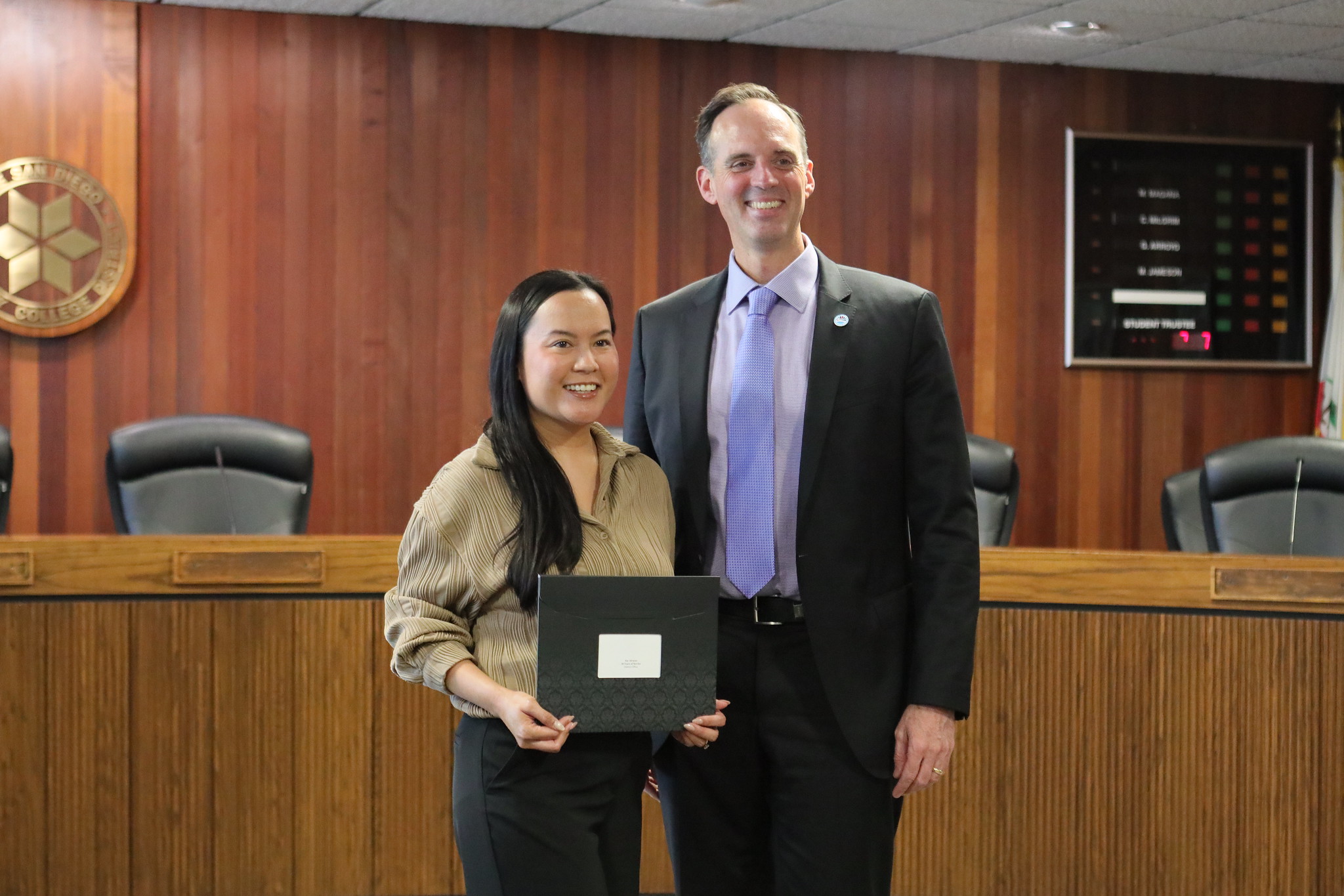 
Chancellor Gregory Smith gives a service award to someone on his staff
