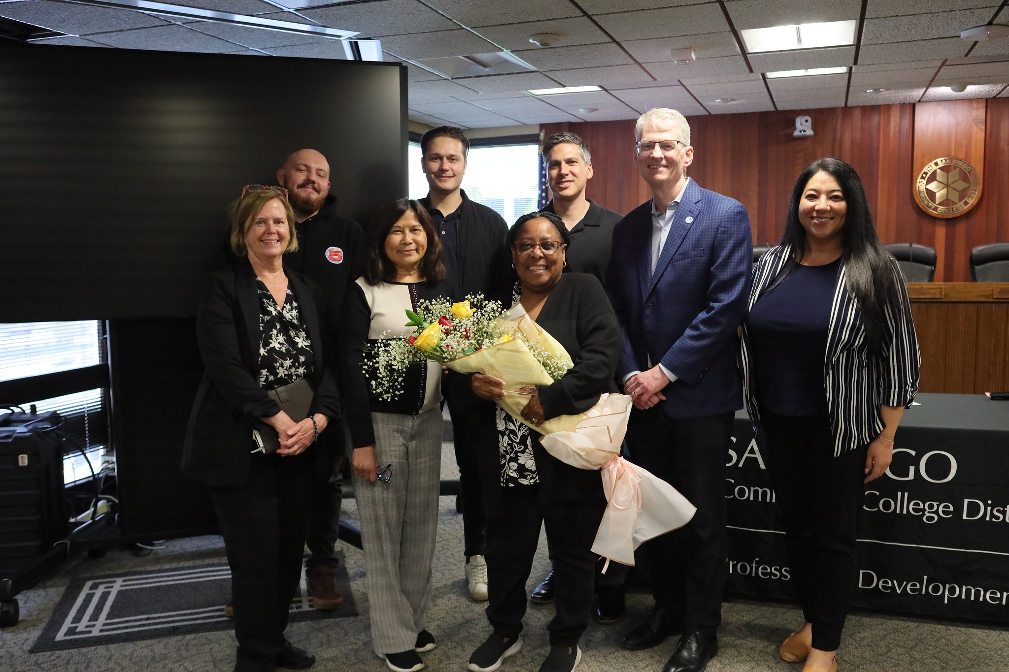 
Employee of the year Renee Darden holds a large bouquet of flowers. She is with seven others from the Business and Finance Division.
