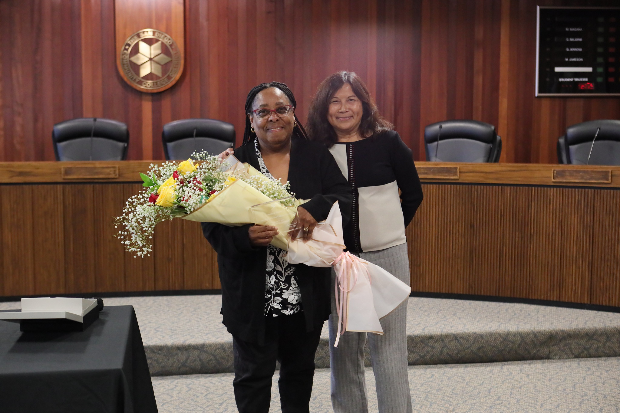 
Employee of the year Renee Darden holds a large bouquet of flowers.
