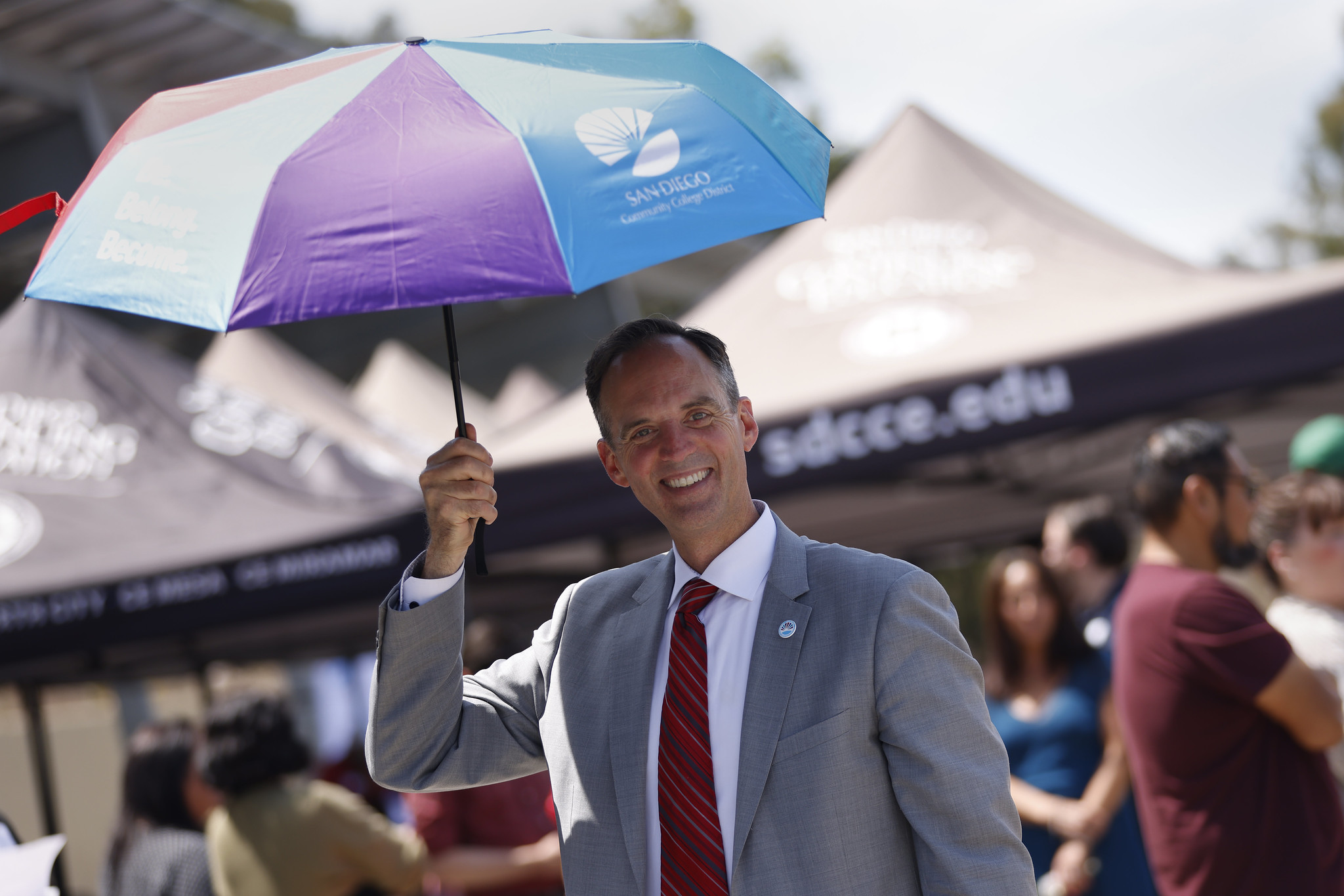 
Chancellor Gregory Smith tries out one of the new district umbrellas that were handed out at the party.

