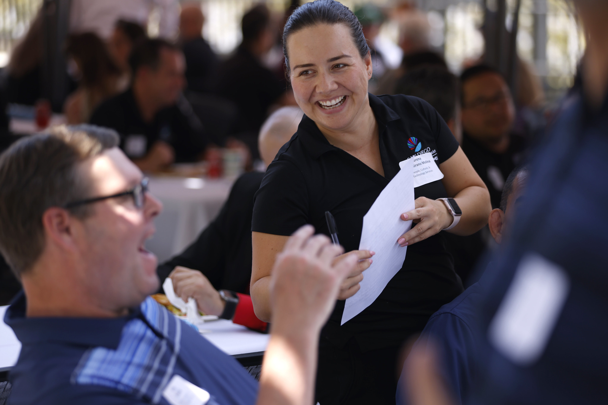 
Two employees try out one of the games where you toss a weighted rope around a bar.
