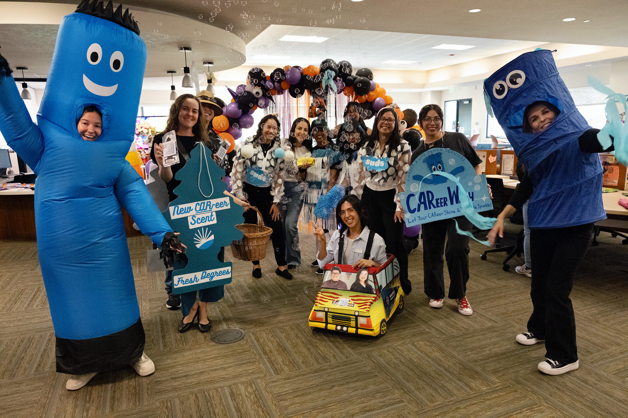 
Eleven people with a group costume who are dressed up as various parts of a car wash.
