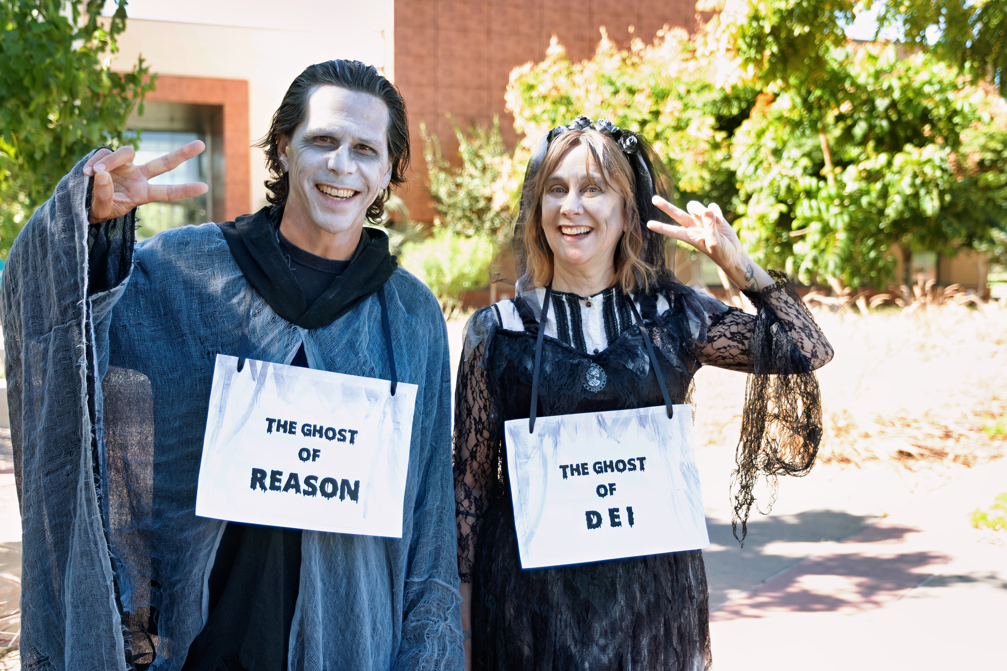 
Two people dressed as ghosts.
