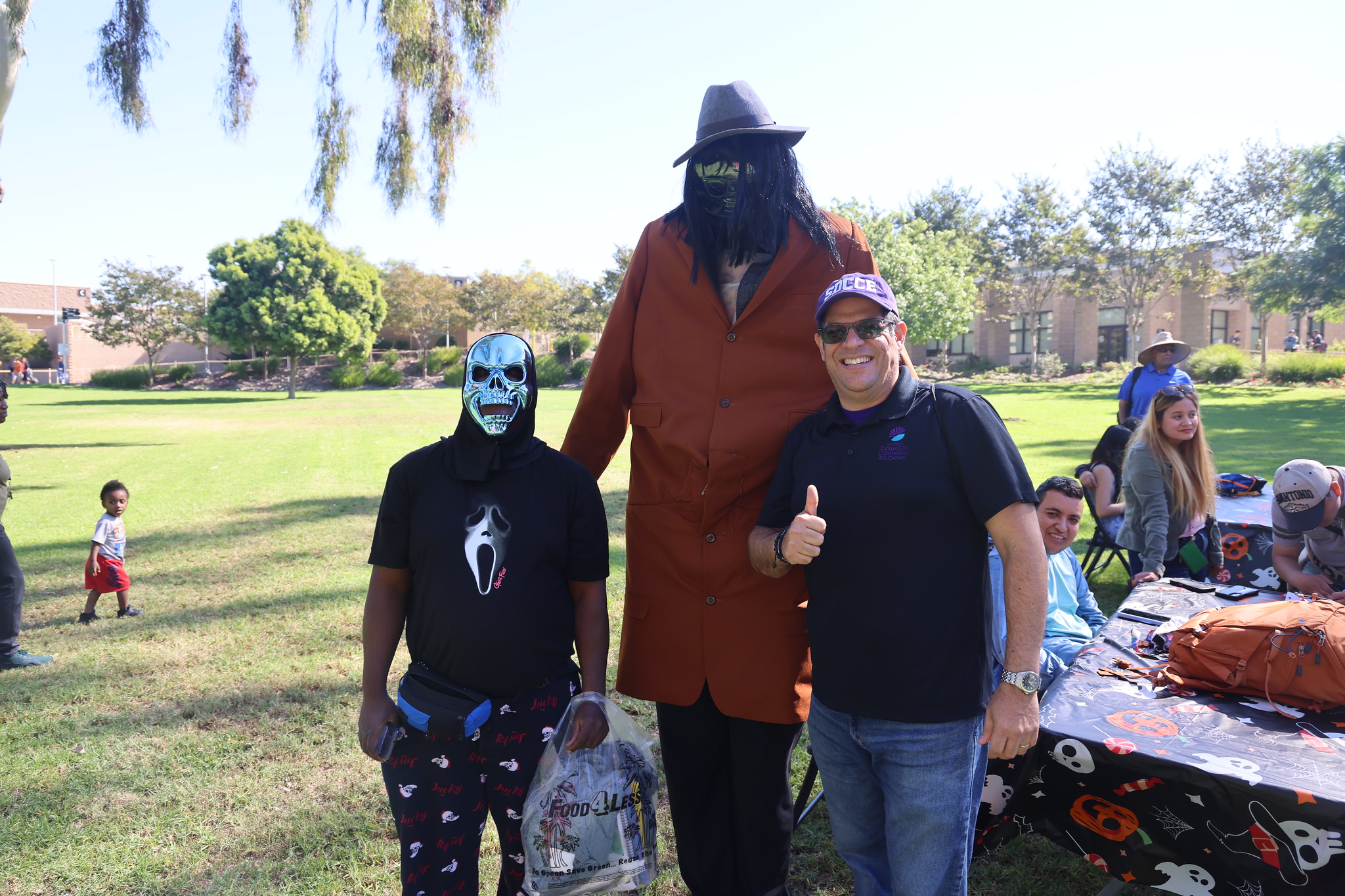 
3 people in Halloween costumes at College of Continuing Education.
