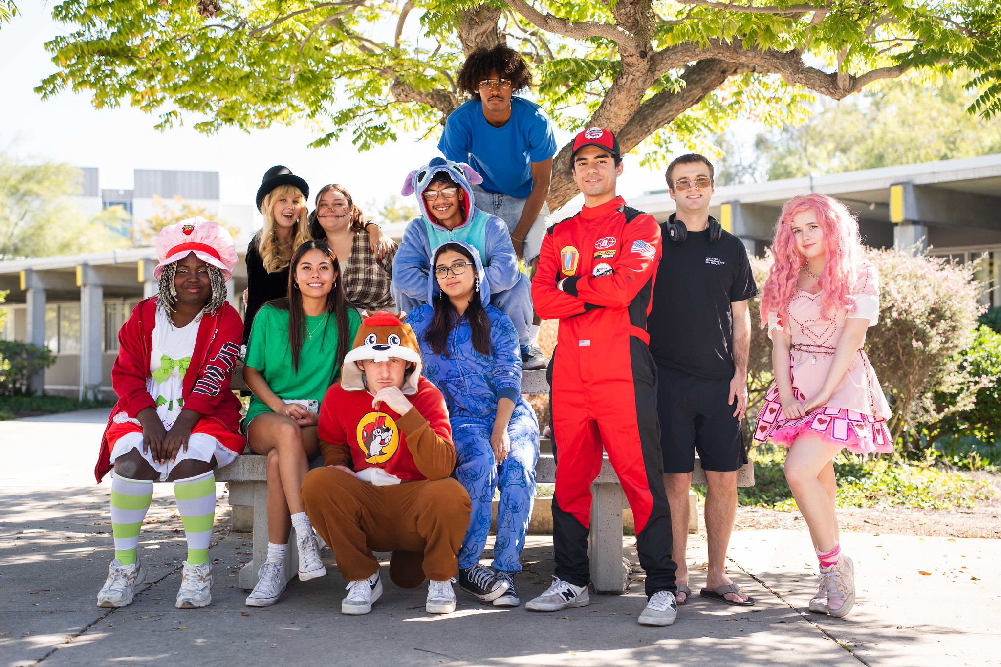 
11 people in various Halloween costumes at City College.
