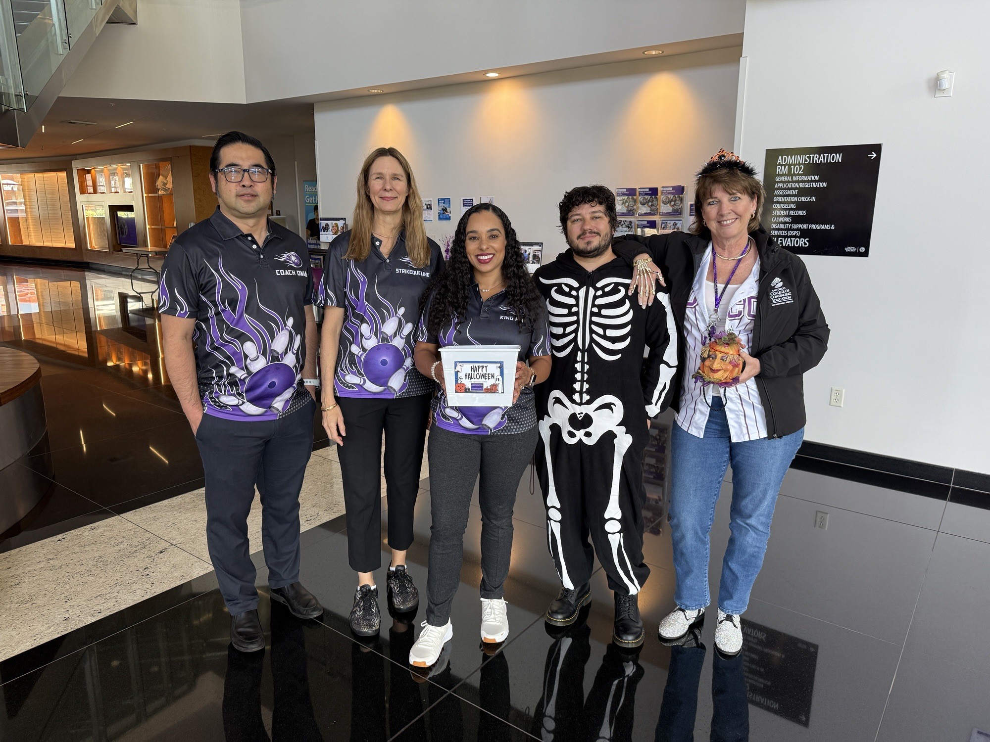 
College of Continuing Education President Tina King with four people on Halloween.
