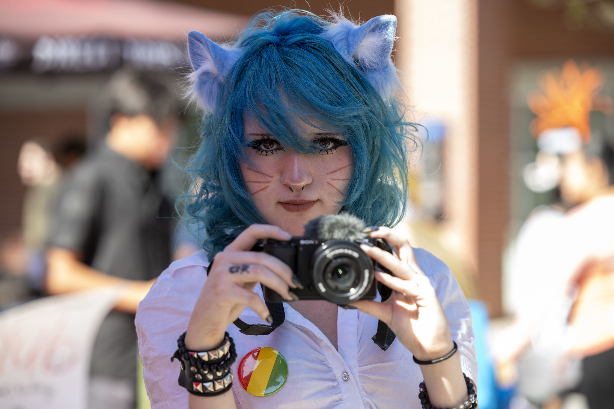 
A woman with a blue wig and cat ears.
