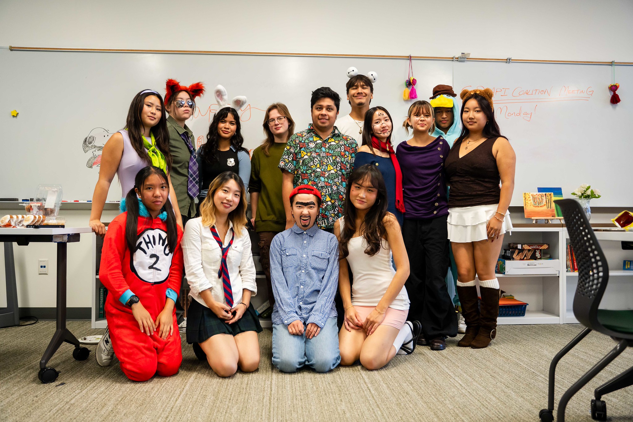 
13 people wearing various Halloween costumes.
