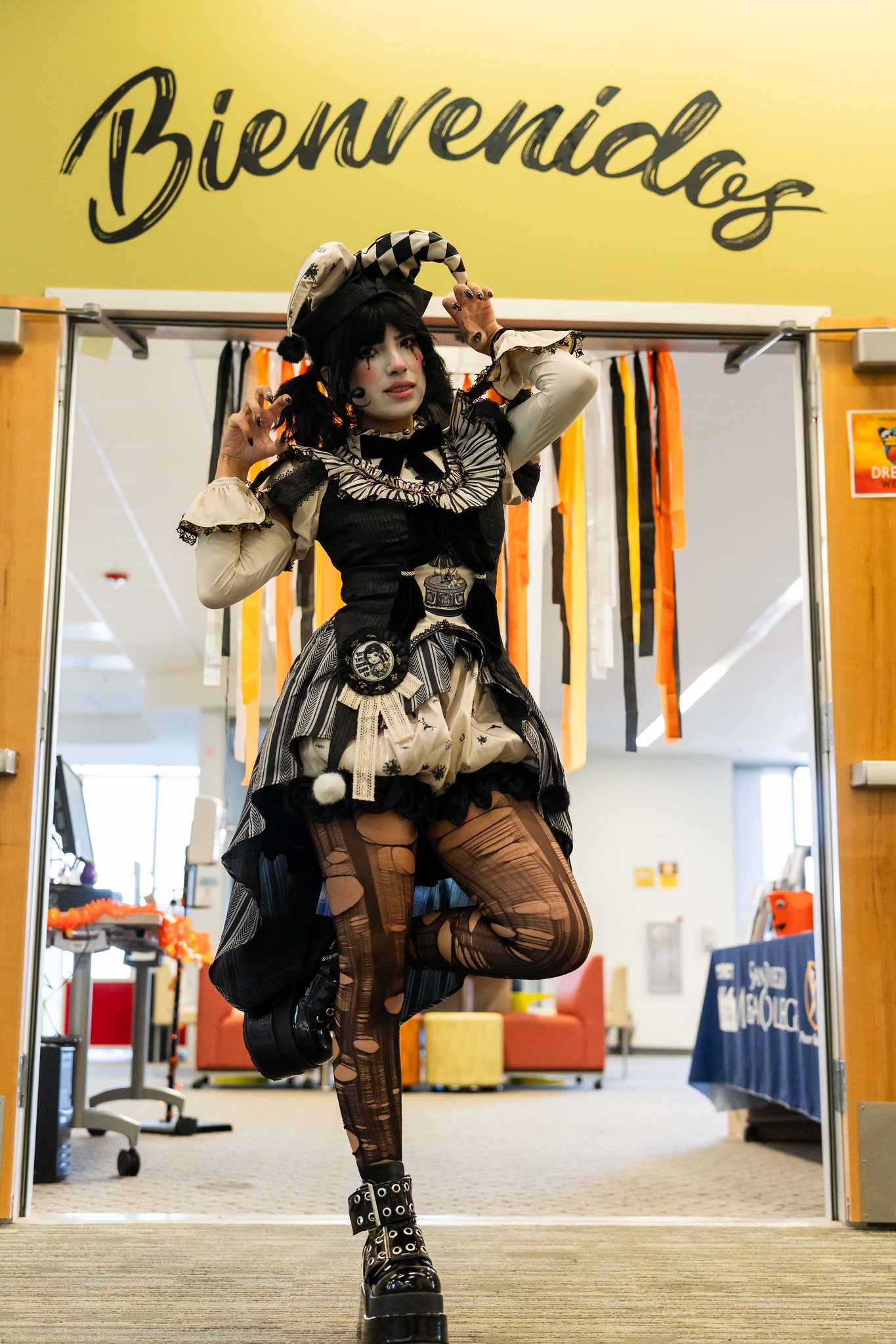 
A woman dressed in a black and white harlequin costume.
