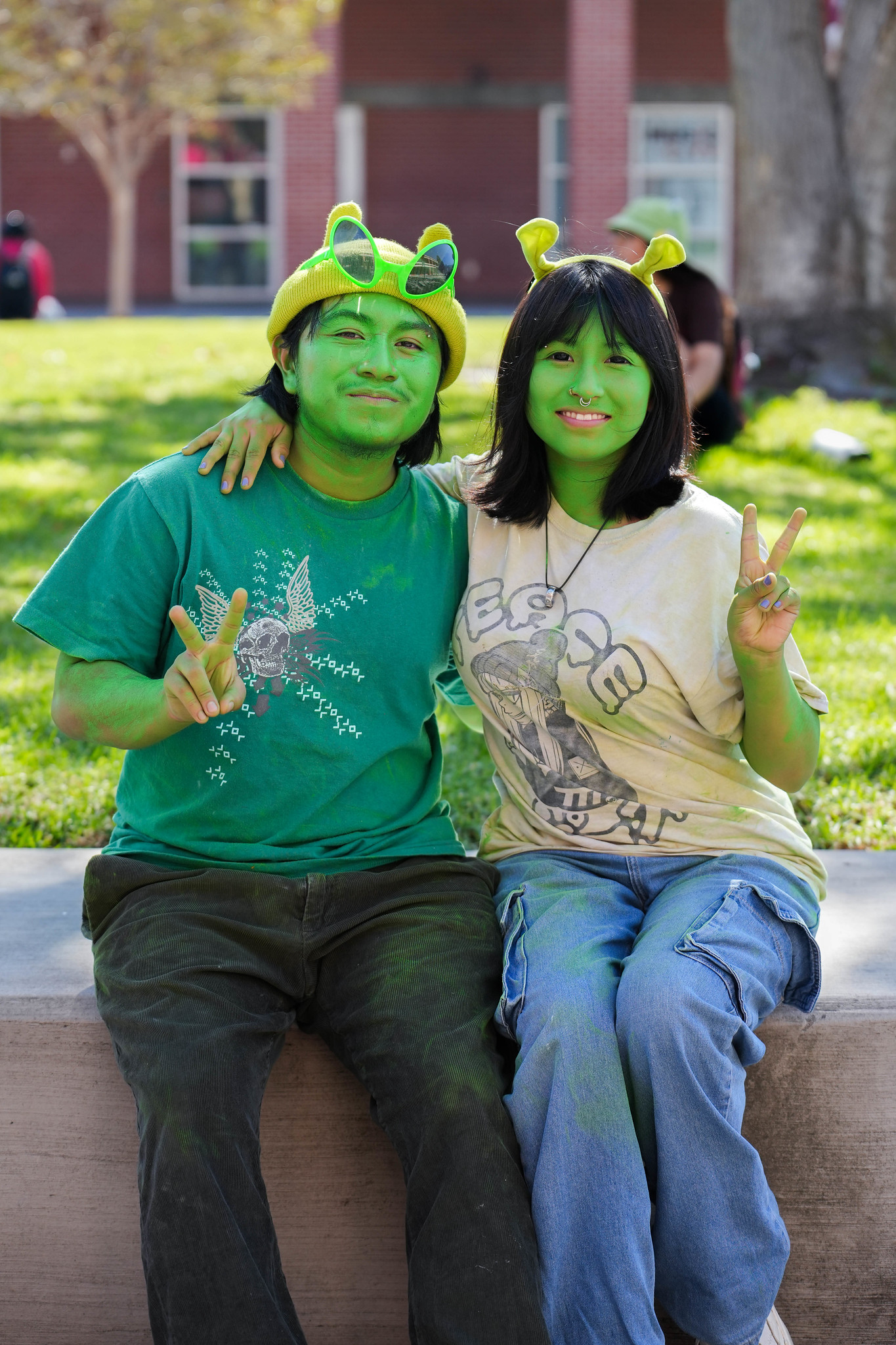 
Two people painted green with Shrek ears
