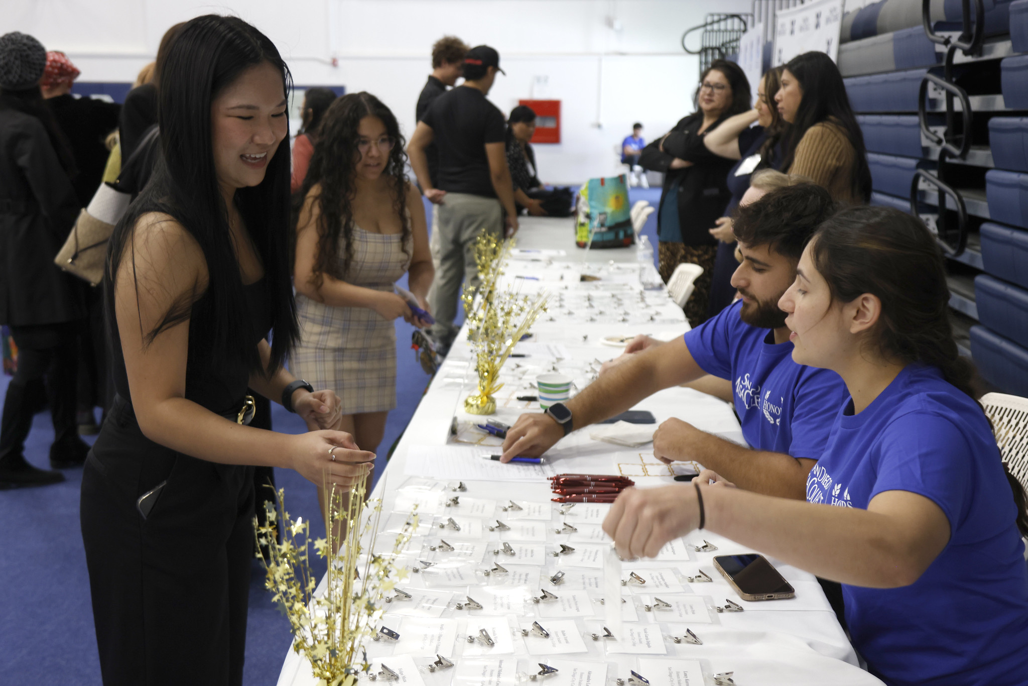 
A guest at the check in table looks for her name badge.
