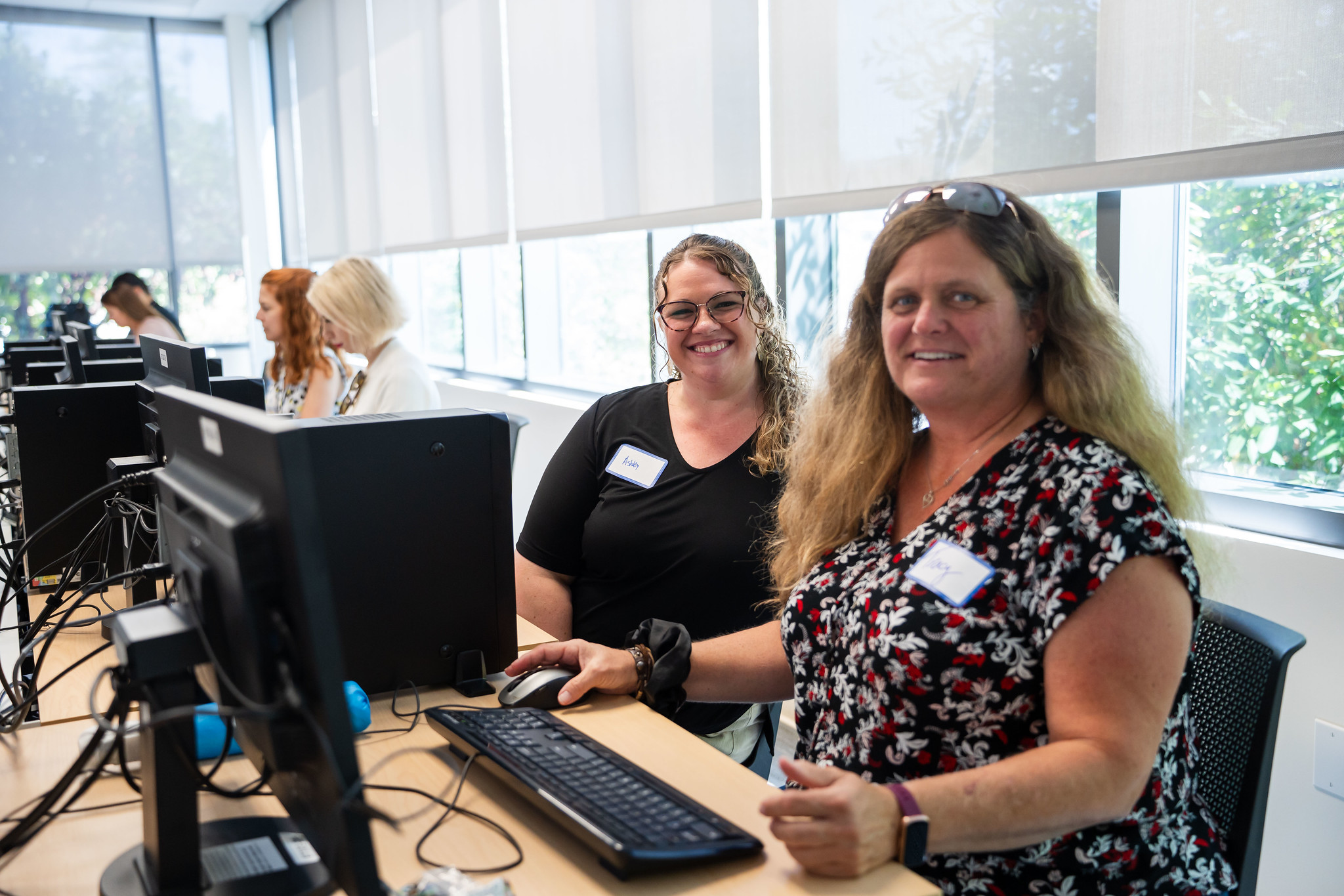 
Two ladies in a computer lab for an activity during convocation.
