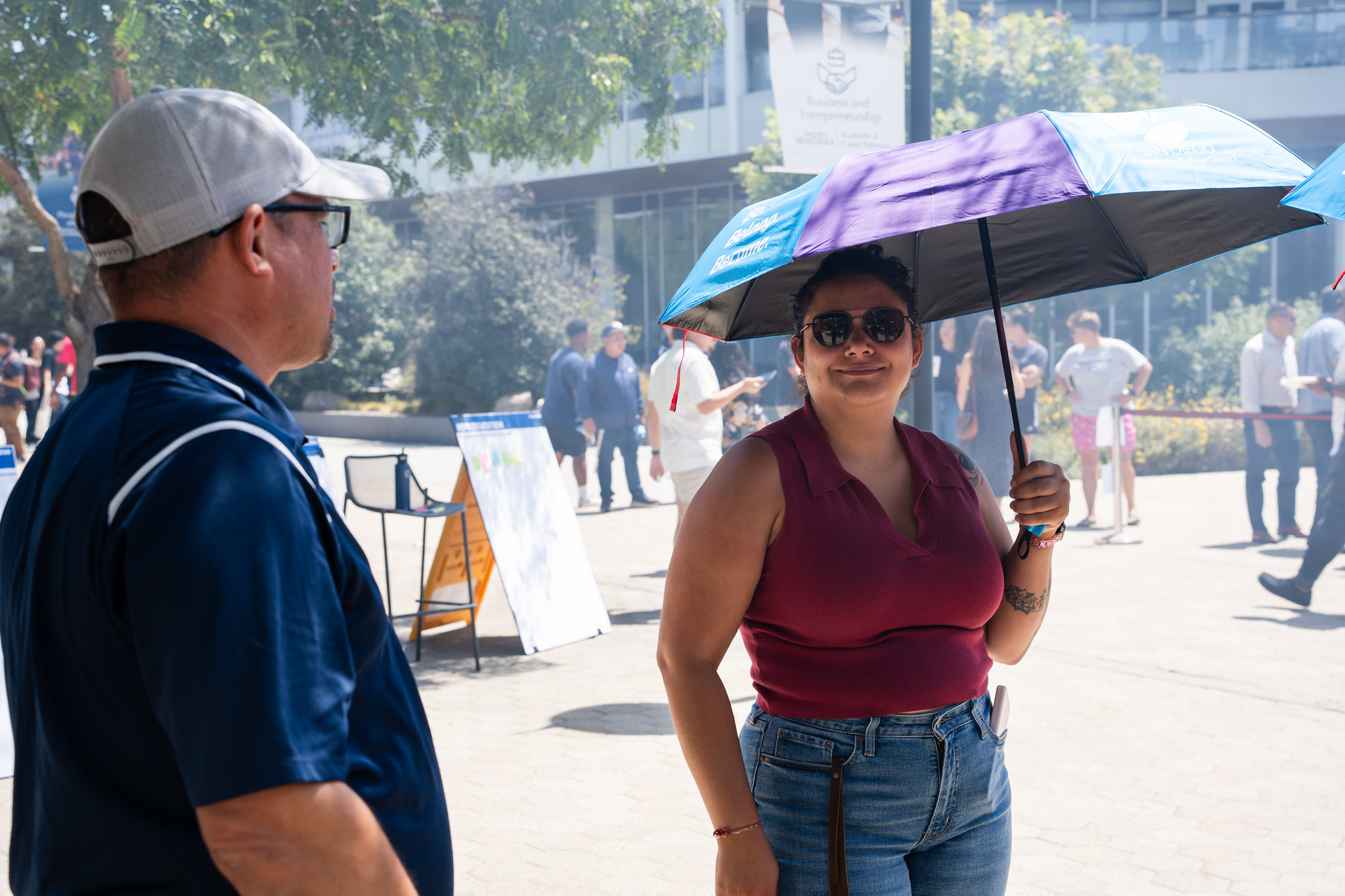 
An employee stands under a district umbrella that was handed out at the event.
