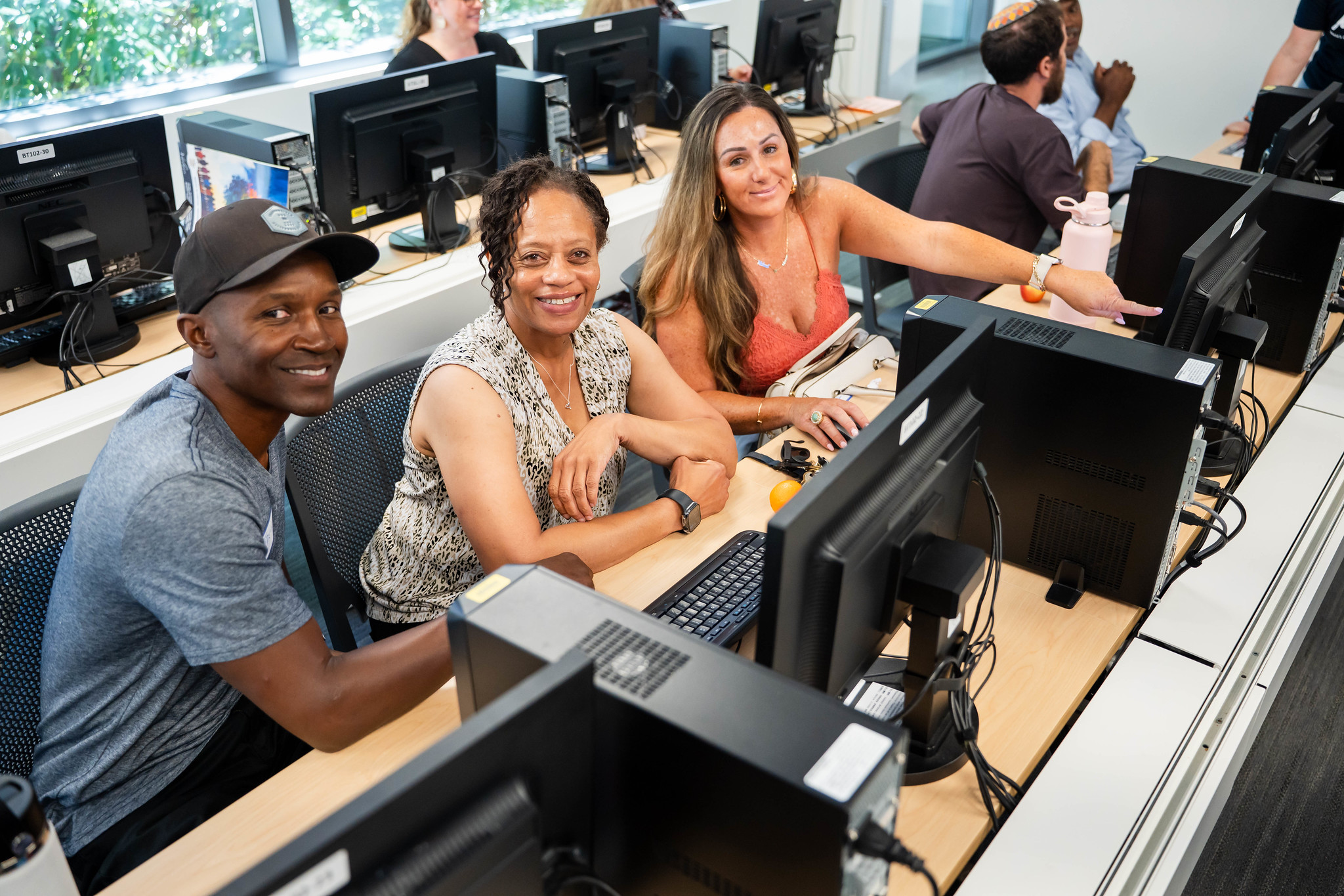 
Three people in a computer lab for an activity at convocation.
