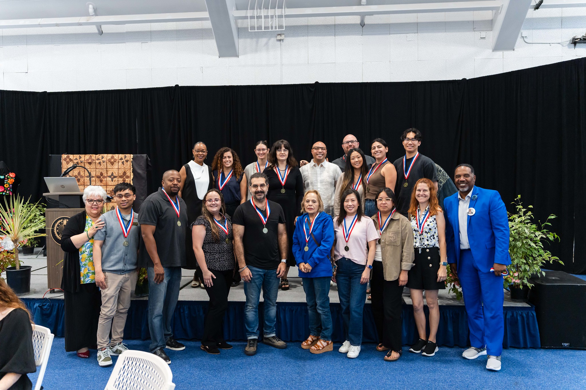 
19 people pose for a group photo.

