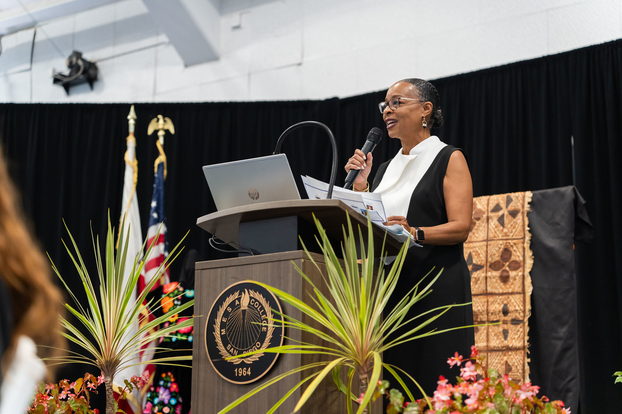 
Mesa President Ashanti Hands on stage speaking to the audience.

