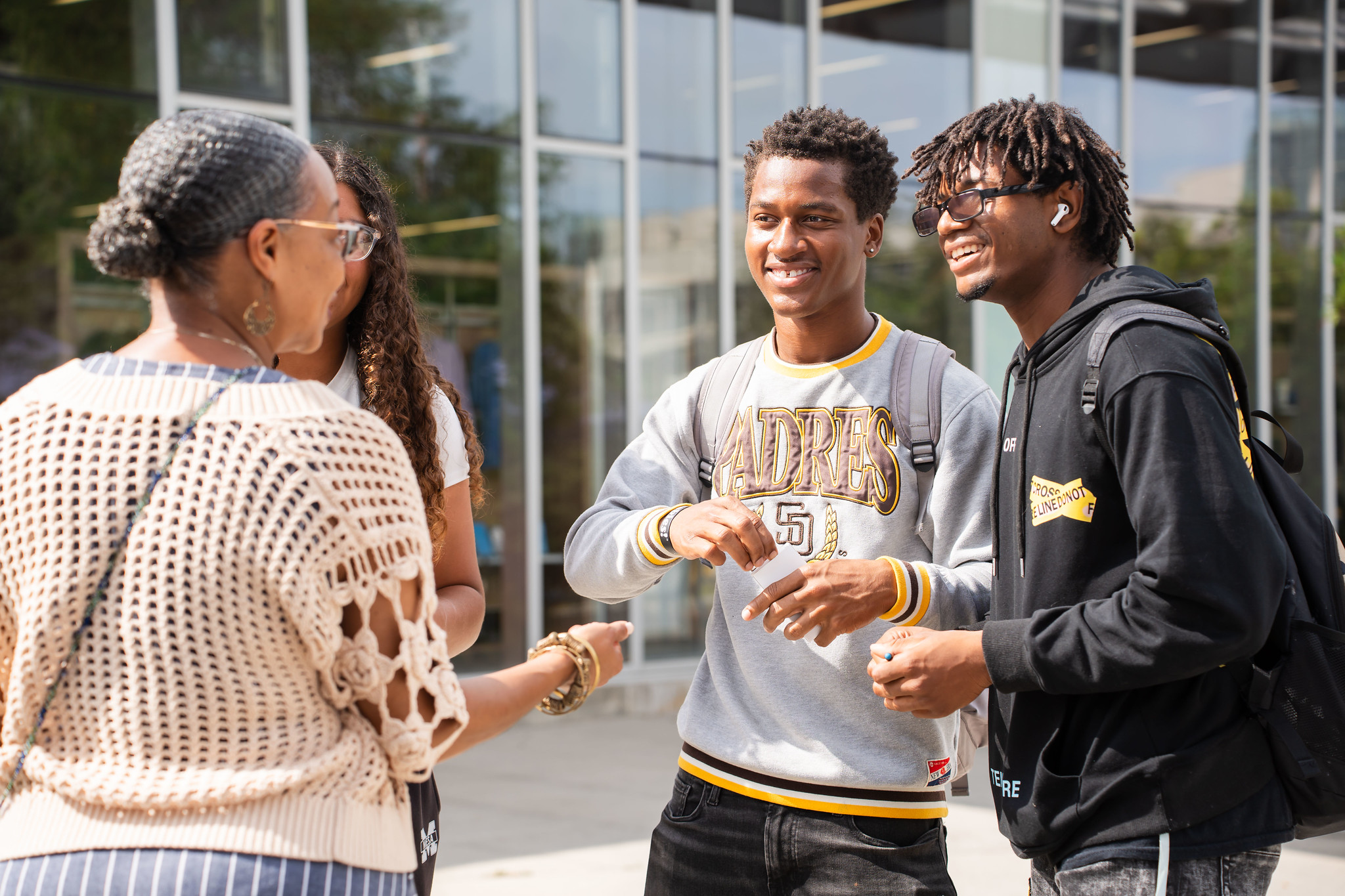 
Two students talk to Mesa College President Ashanti Hands.
