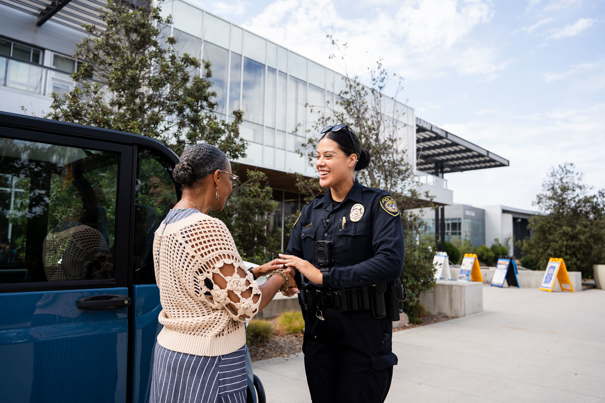 
Mesa College President Ashanti Hands shakes hands with a College Police Campus Service Officer
