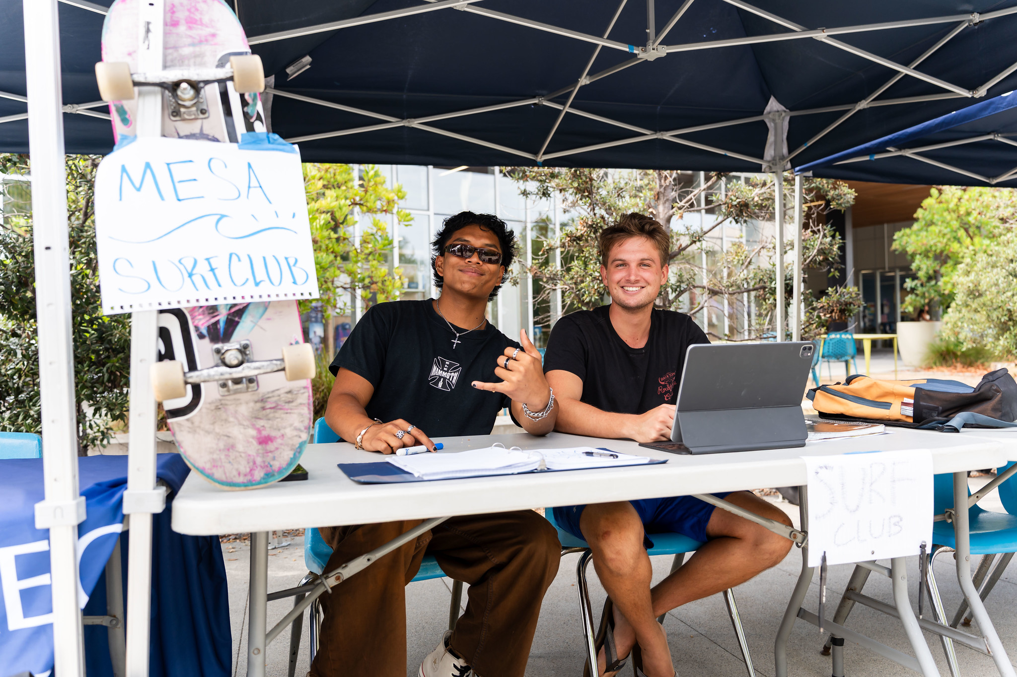 
Two students running a welcome tent for the surf club
