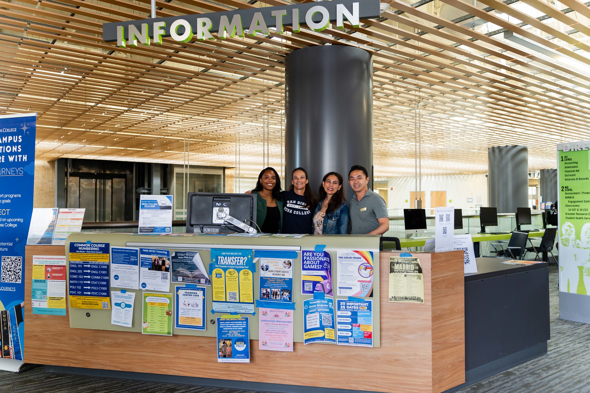 
Three people working at the information desk.
