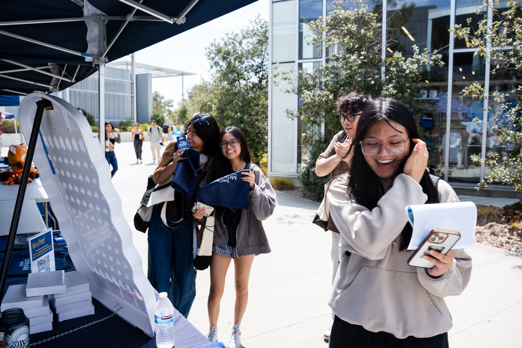
A student wins a prize playing plinko at a welcome tent.
