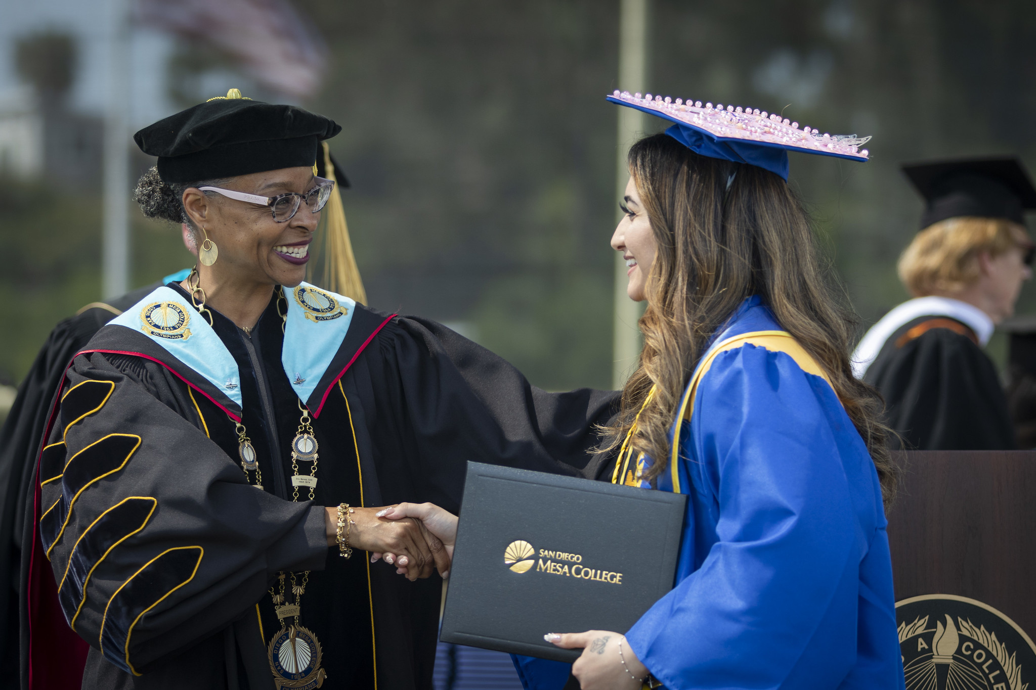 
Mesa College President Ashanti Hands shakes a graduate's hand after receiving her degree.
