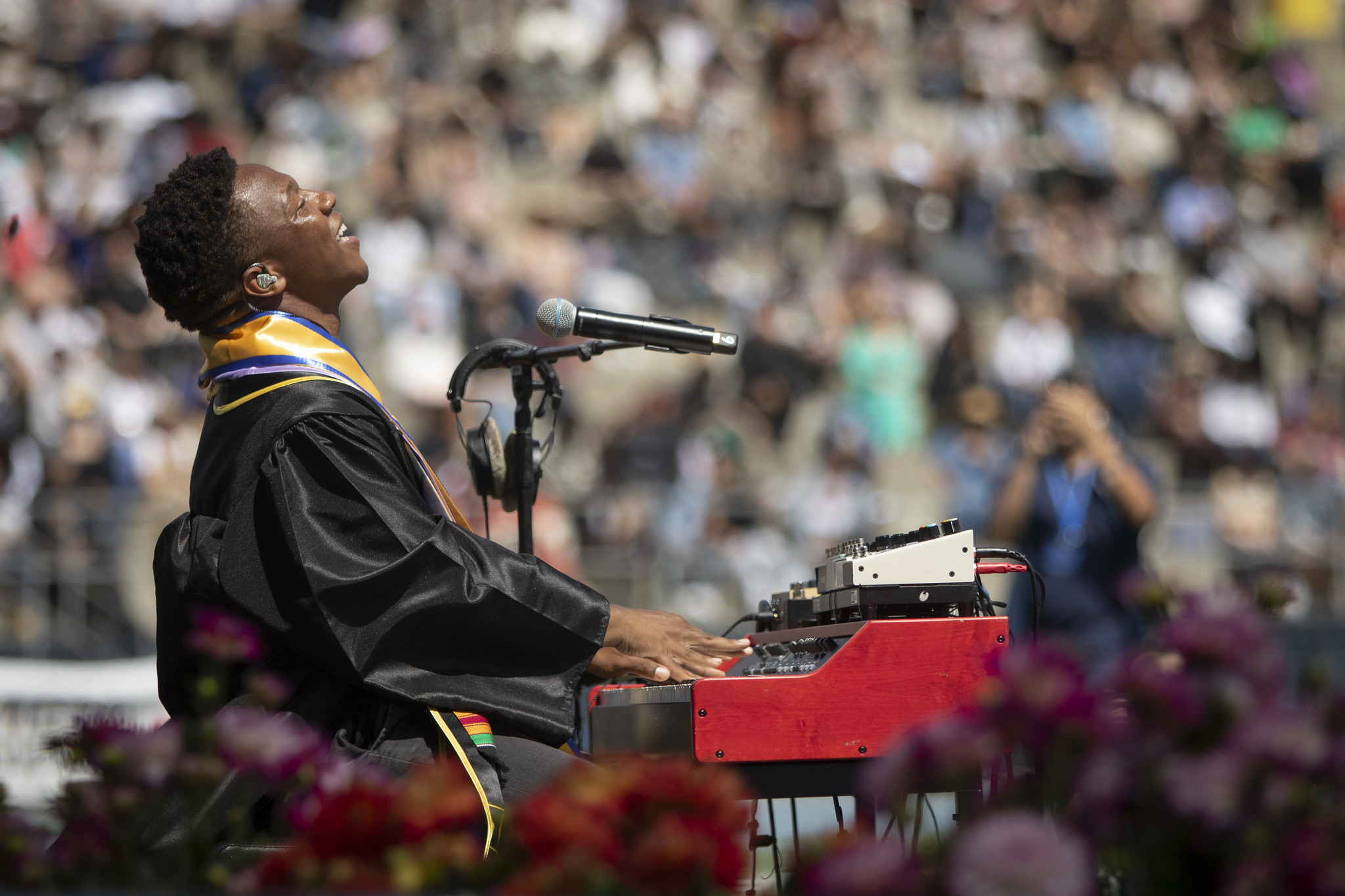 
Angel Wilson sitting a keyboard sings during the commencement ceremony.
