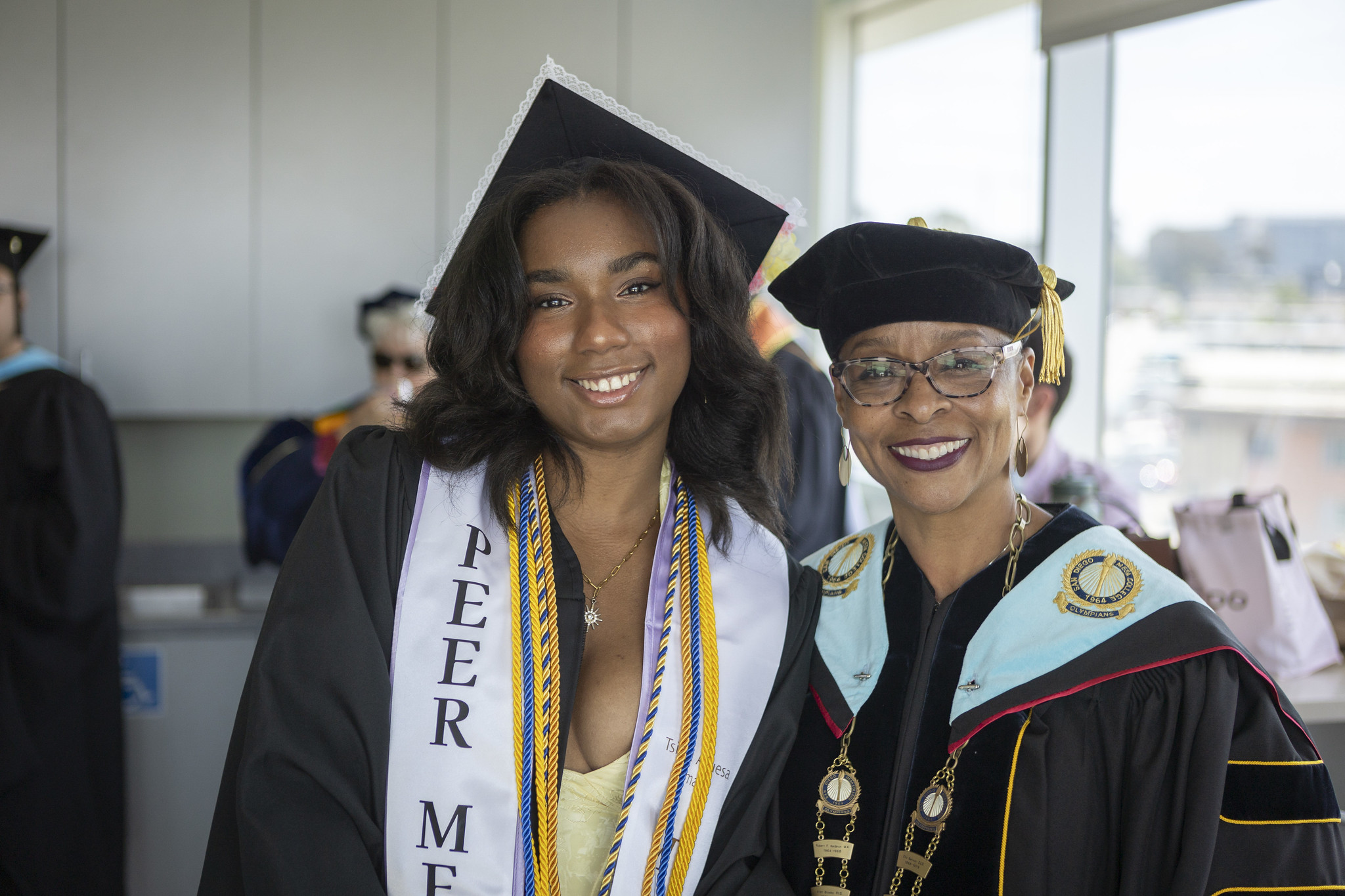 
Mesa College President Ashanti Hands with a graduate as the wait for commencement to begin.
