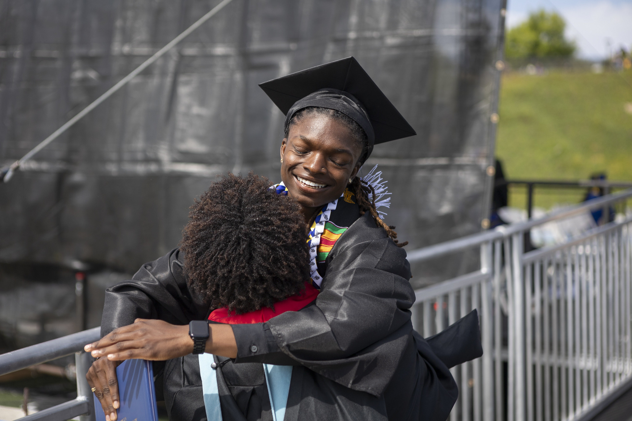 
A student hugs a family member.
