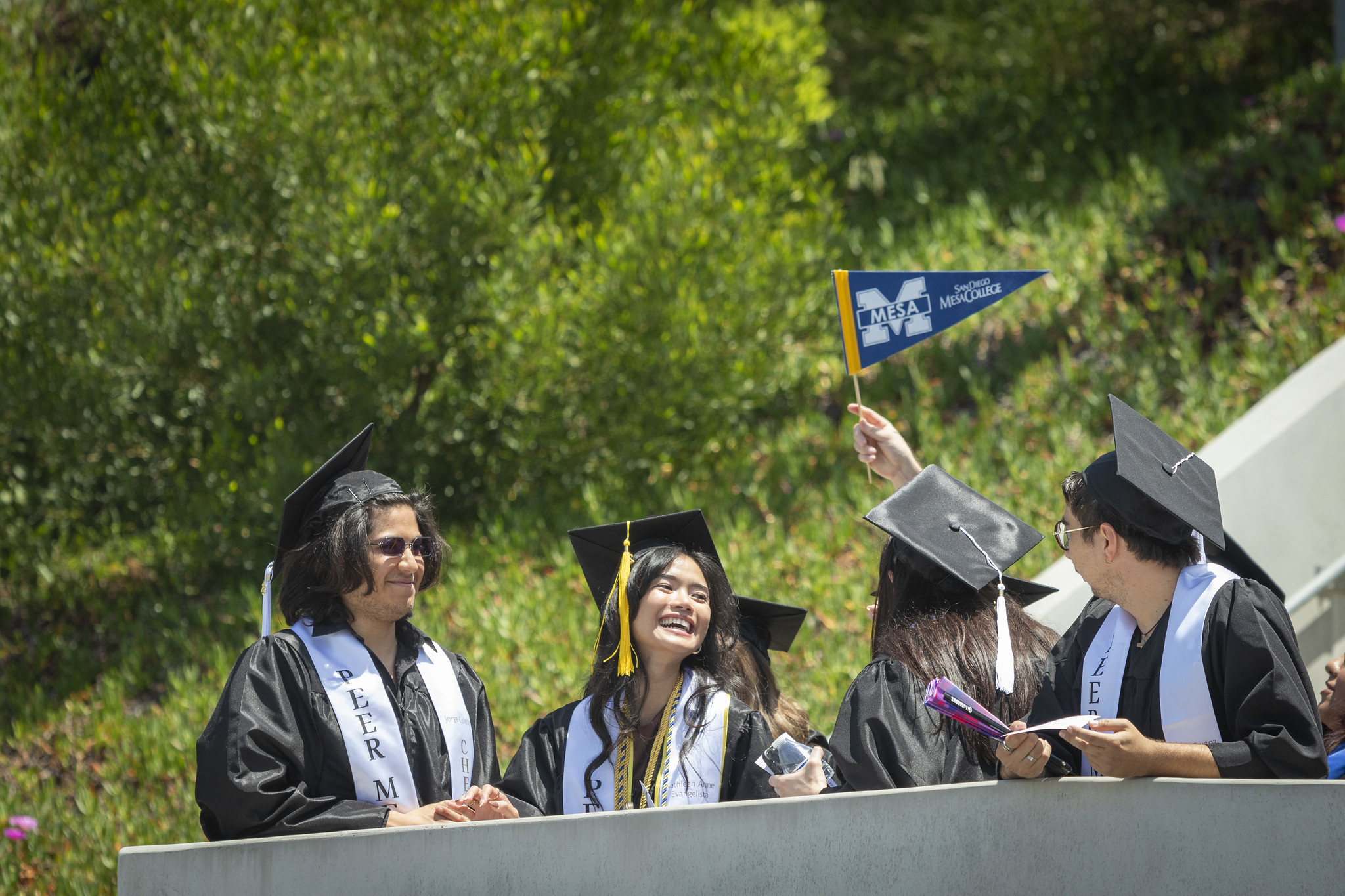 
Four graduates on the ramp entrance to the commencement ceremony.
